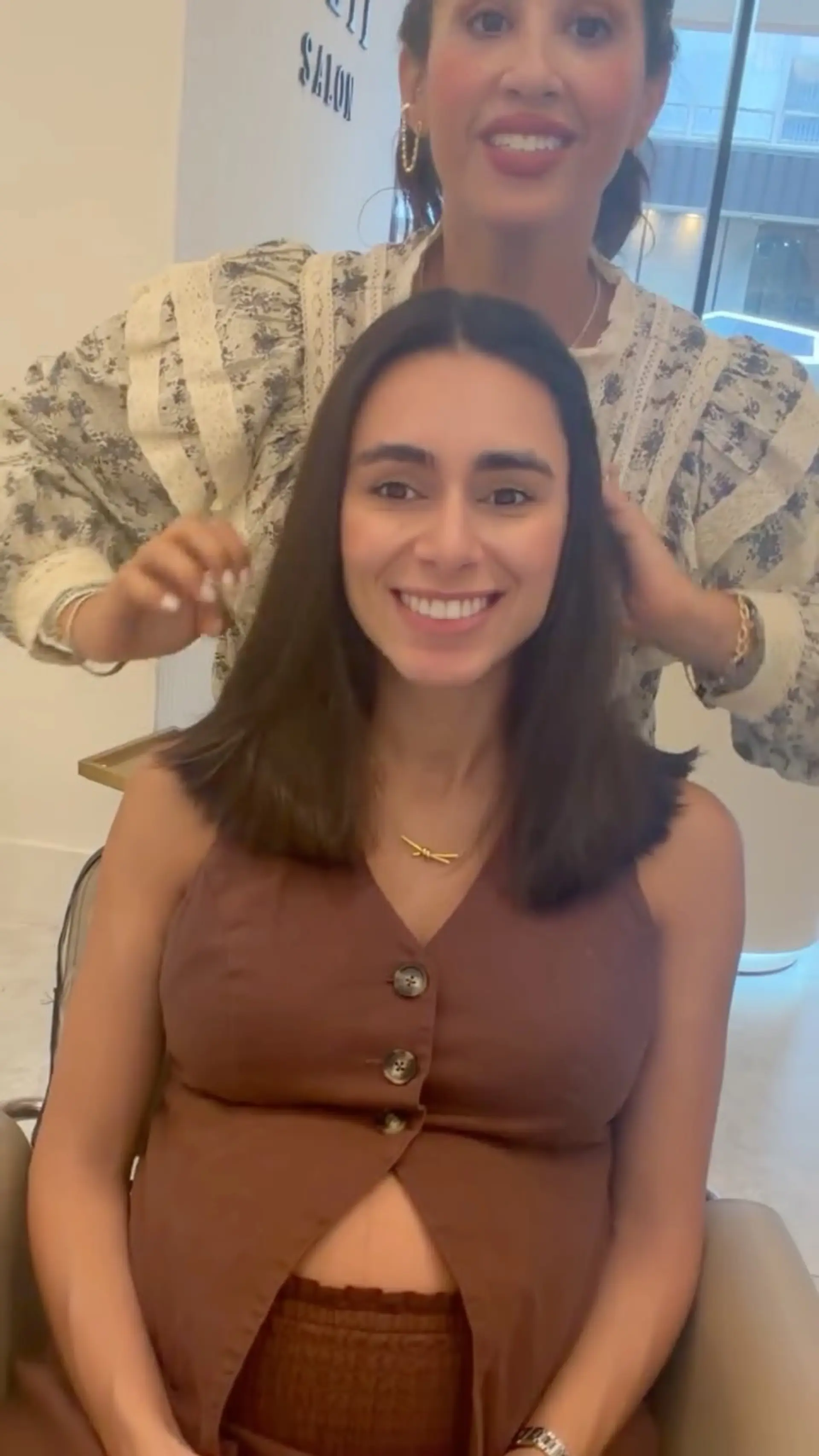 A fresh shoulder-length brunette cut with soft layers, styled straight with natural body and a clean middle part. 1
