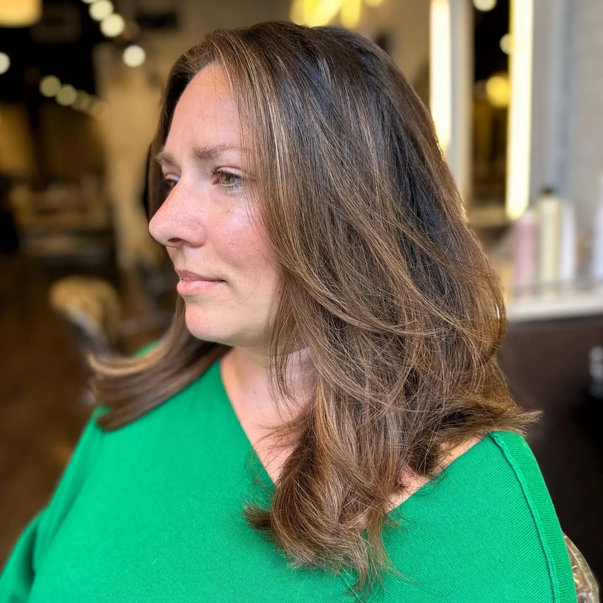 A trendy medium-length layered lob with face-framing highlights and a touch of balayage. 1