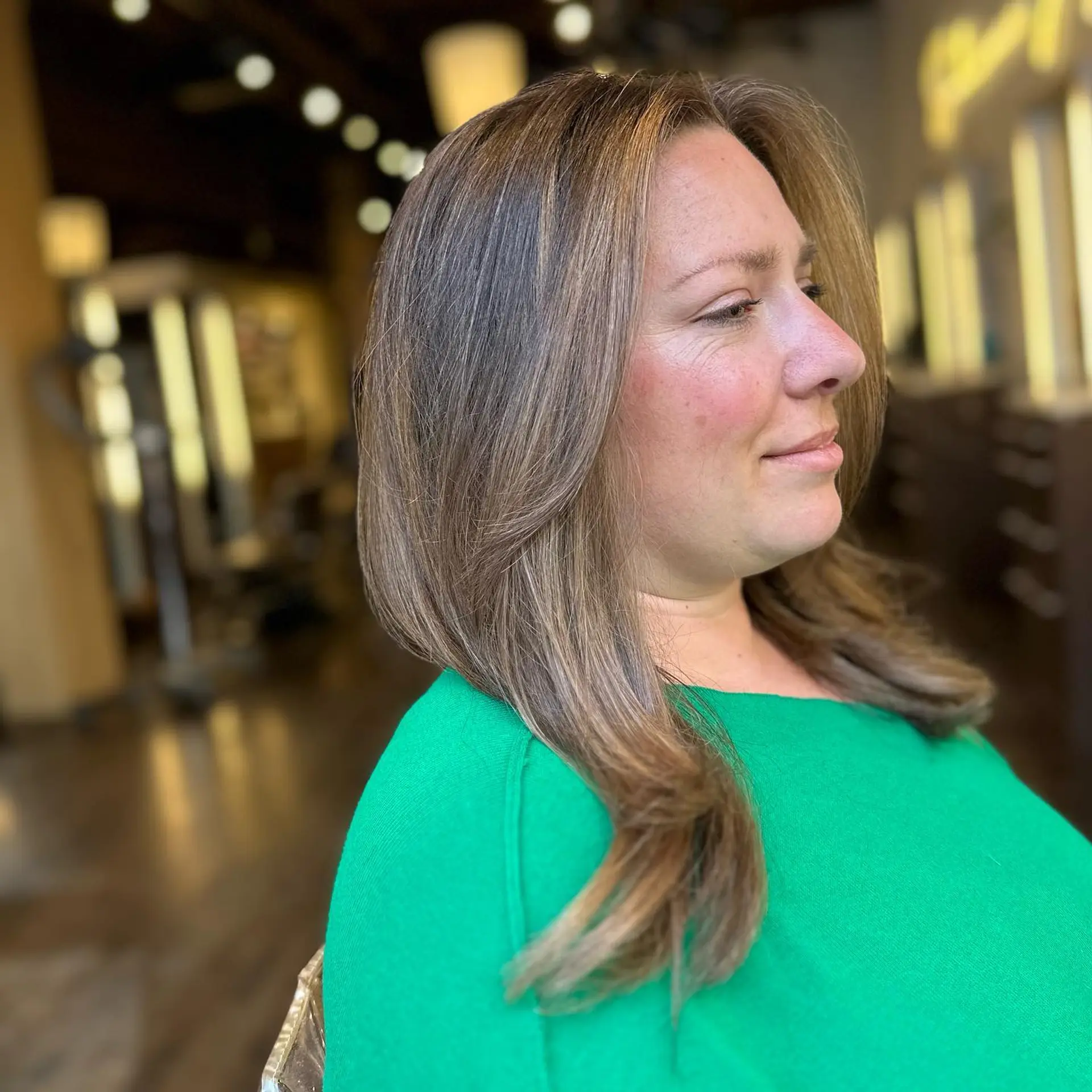 A trendy medium-length layered lob with face-framing highlights and a touch of balayage. 2