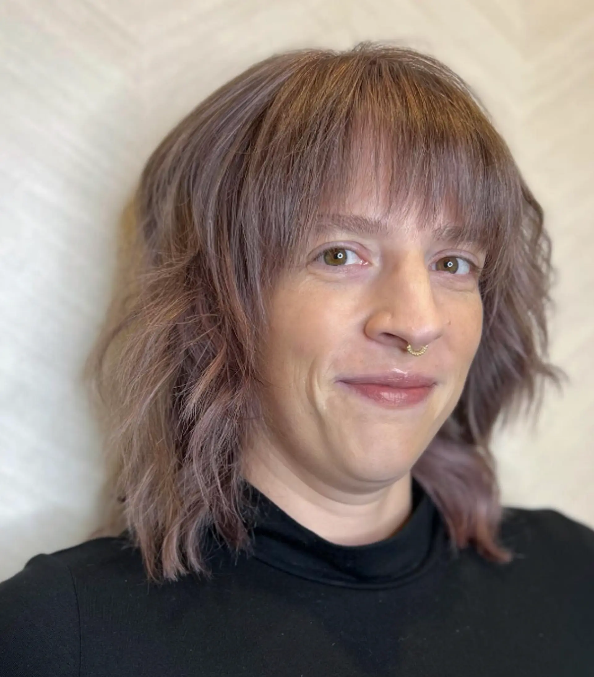 Medium-length wavy cut with tousled texture and fringe bangs in ash brown with subtle highlights.

Color by @simabeautynyc
Cut and style by @juliamannino_hair
 1