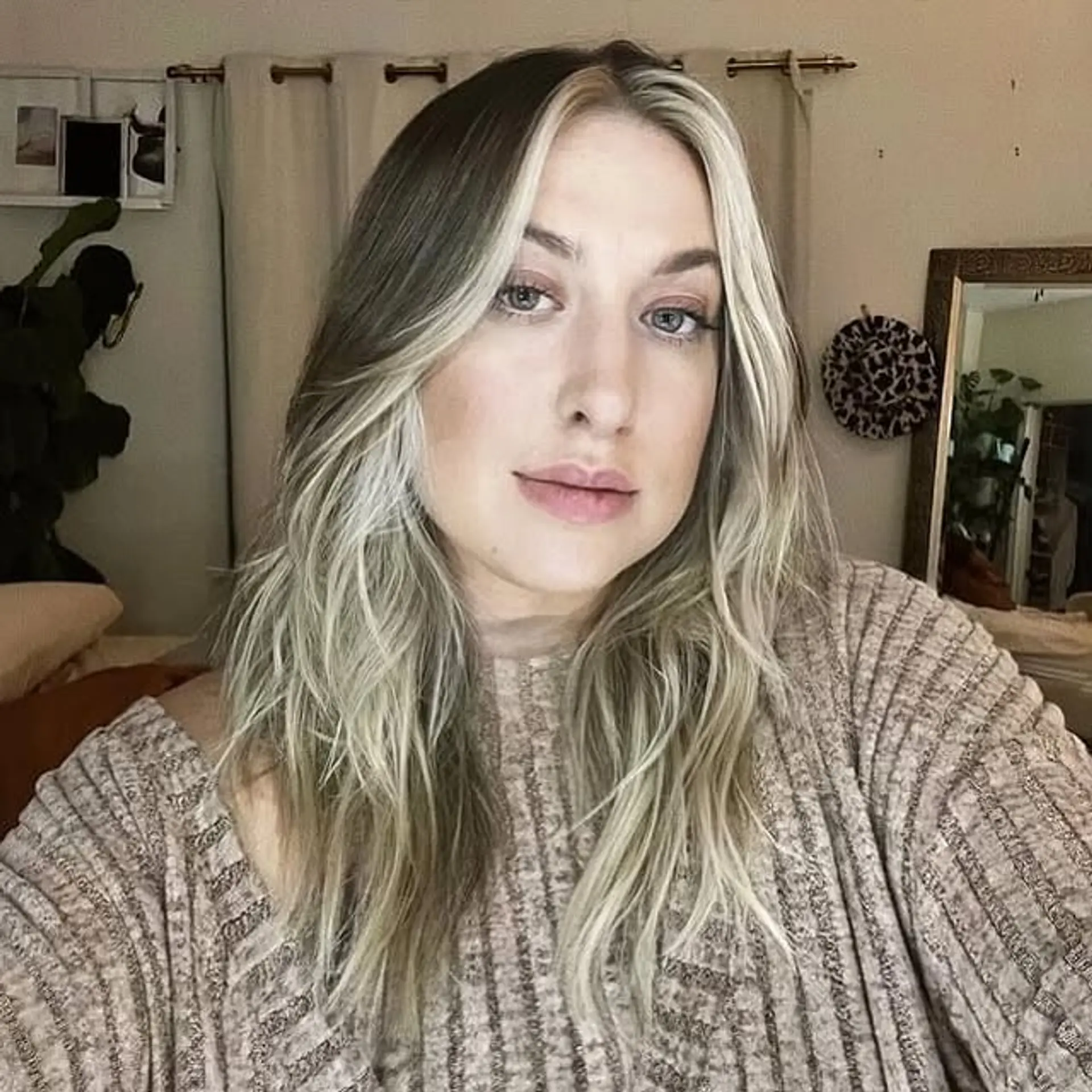 A medium-length wavy hairstyle with bold, face-framing blonde highlights. 1