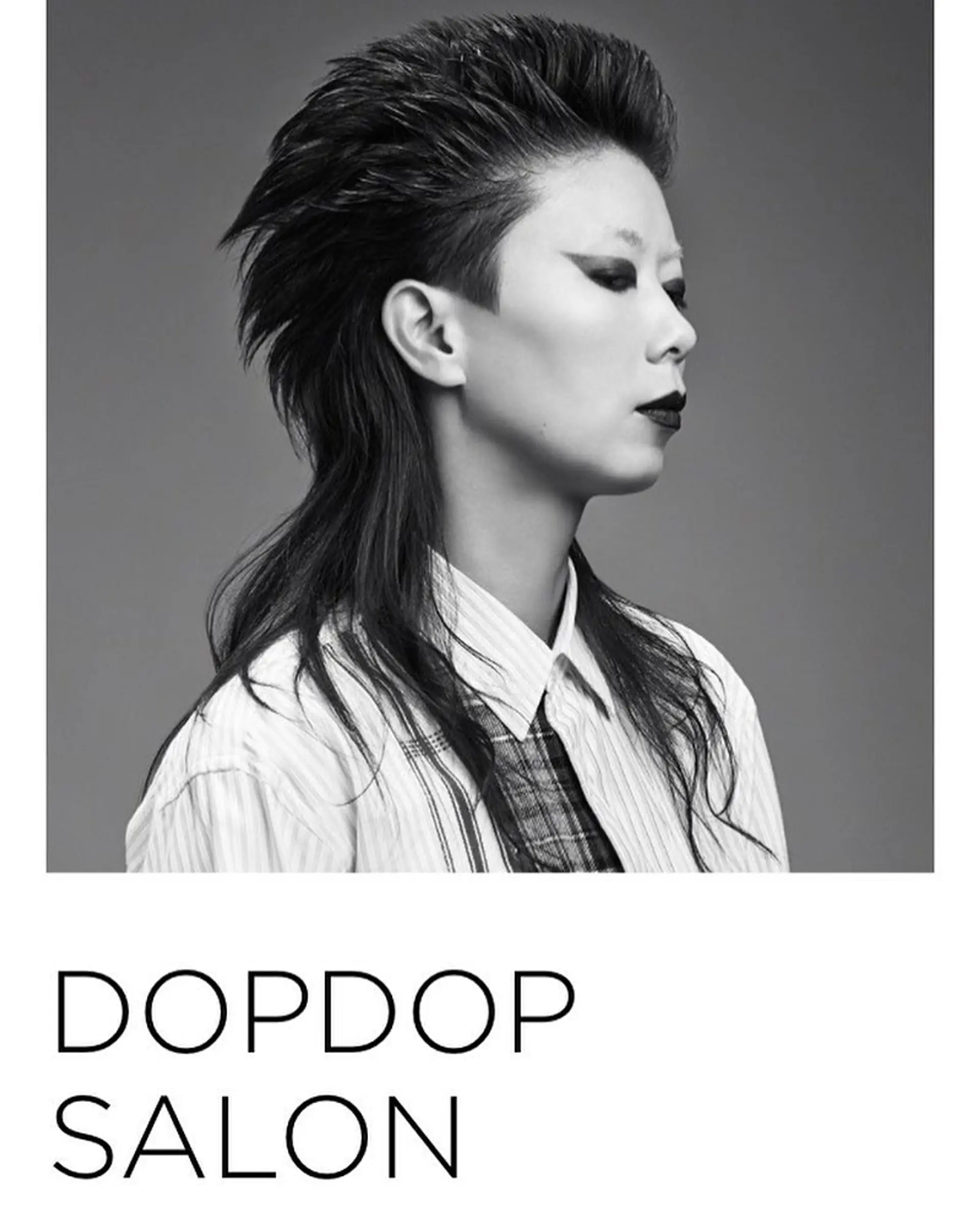 A dramatic modern mullet haircut featuring closely buzzed sides and an intensely textured, swept-back top with longer lengths trailing at the nape. 1
