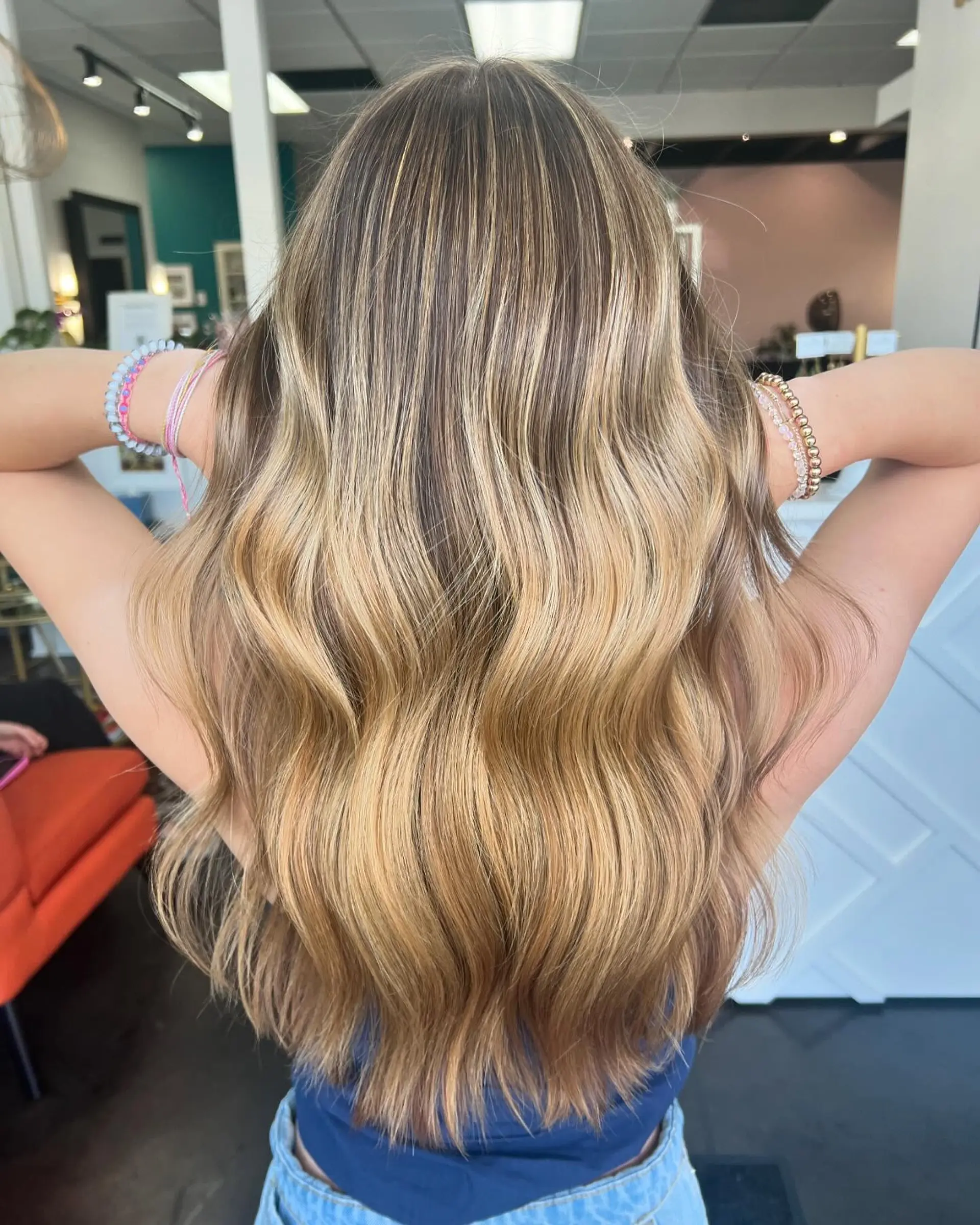 Long dimensional golden blonde hair styled in soft, flowing waves. 1