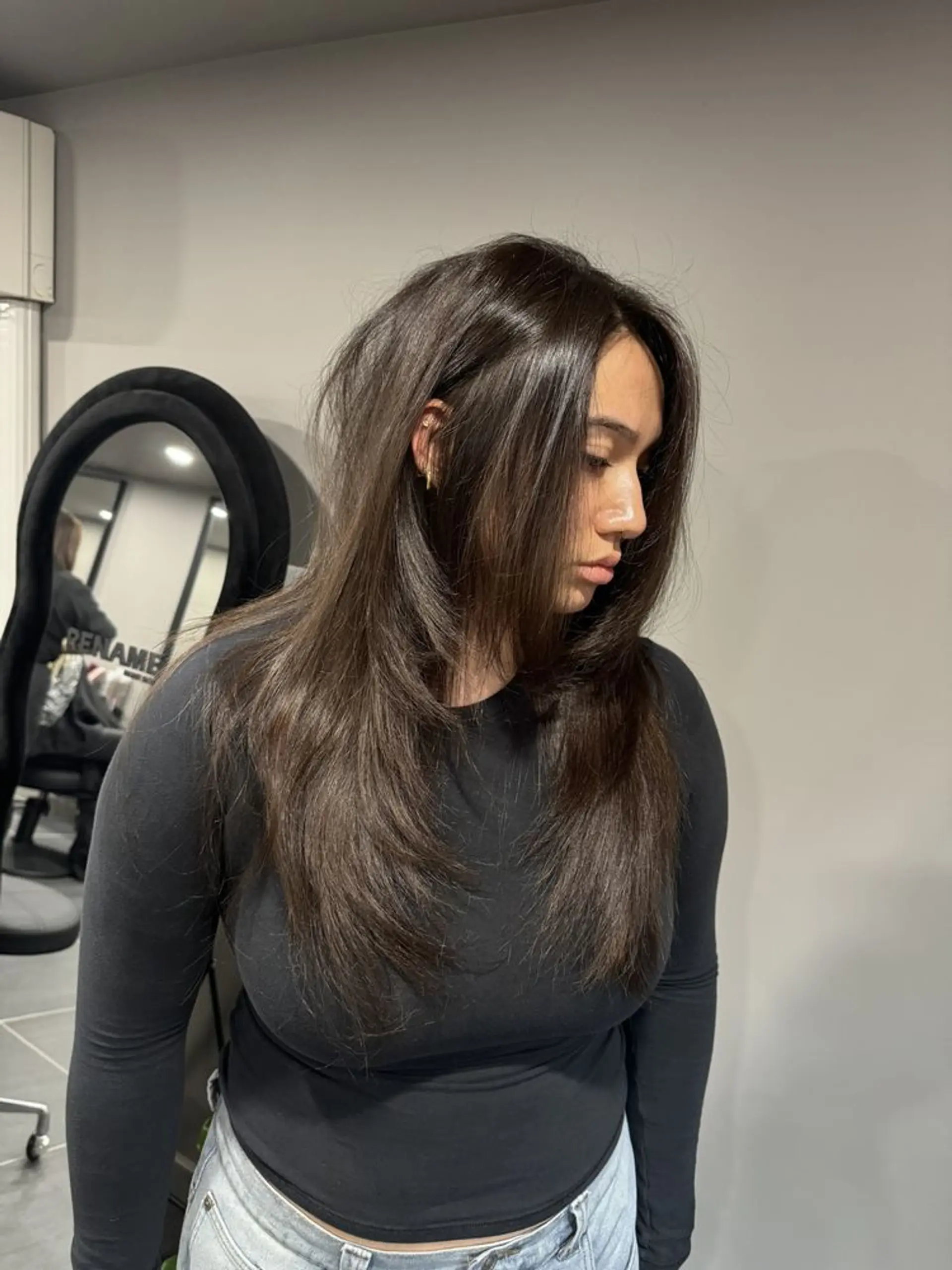 Beautifully sleek cascade of dark brown layers with a side part, featuring medium-length straight hair styled smoothly and naturally, accentuated with dynamic layered cuts. 1