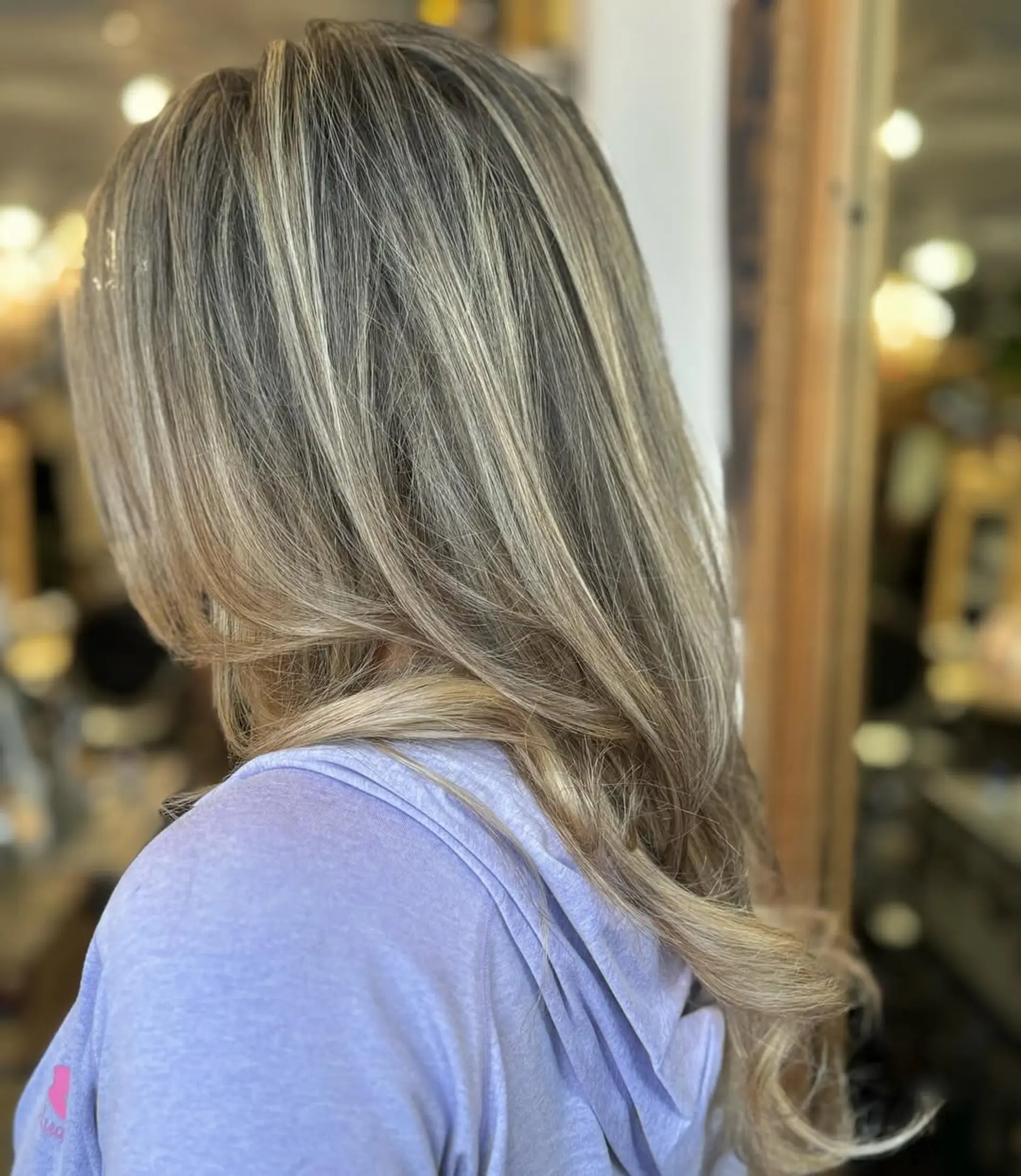 Long, wavy blonde hair with natural highlights, featuring soft, loose waves and layered dimensions. 1