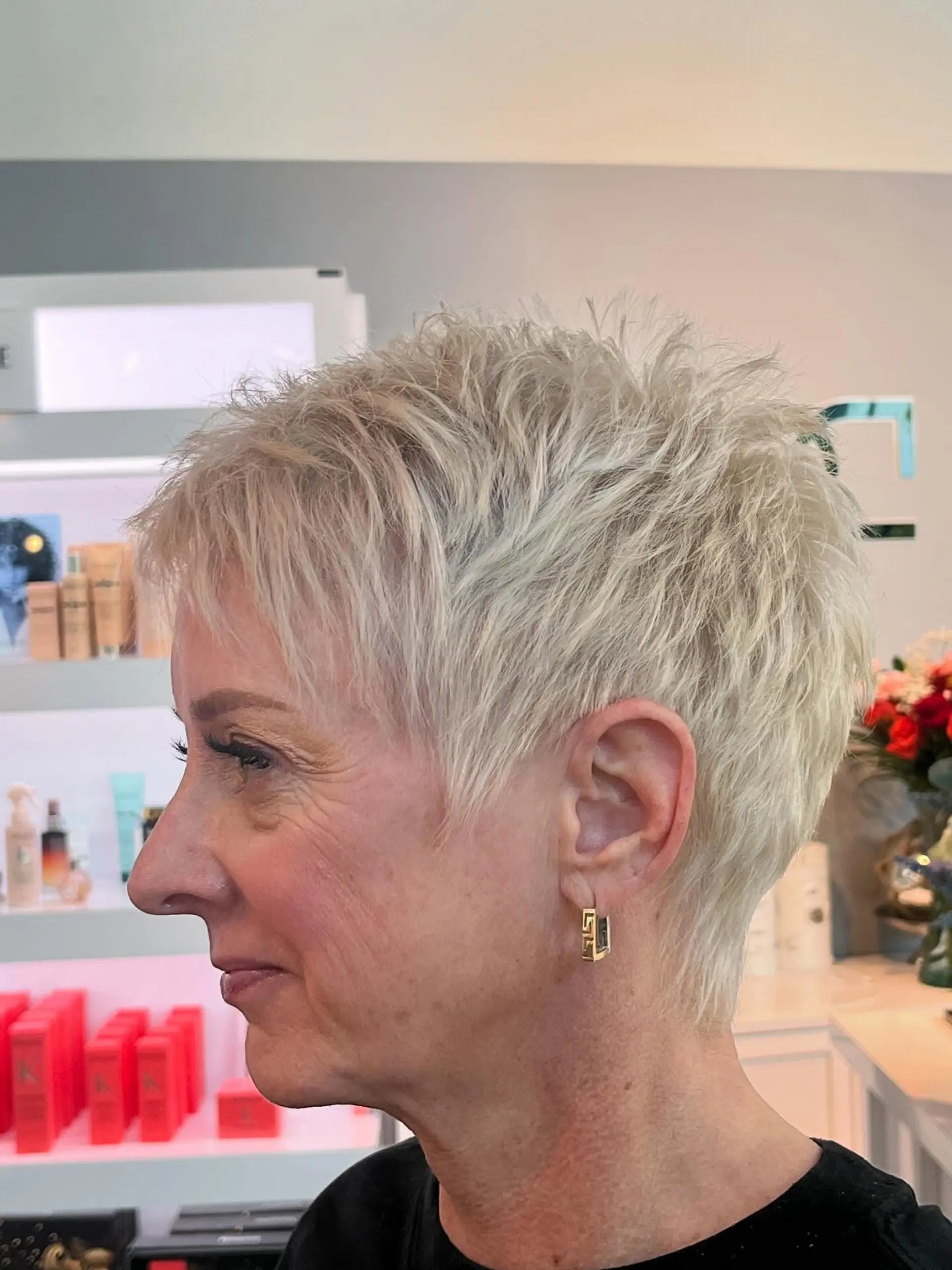A short, textured pixie cut with a layered effect. 1