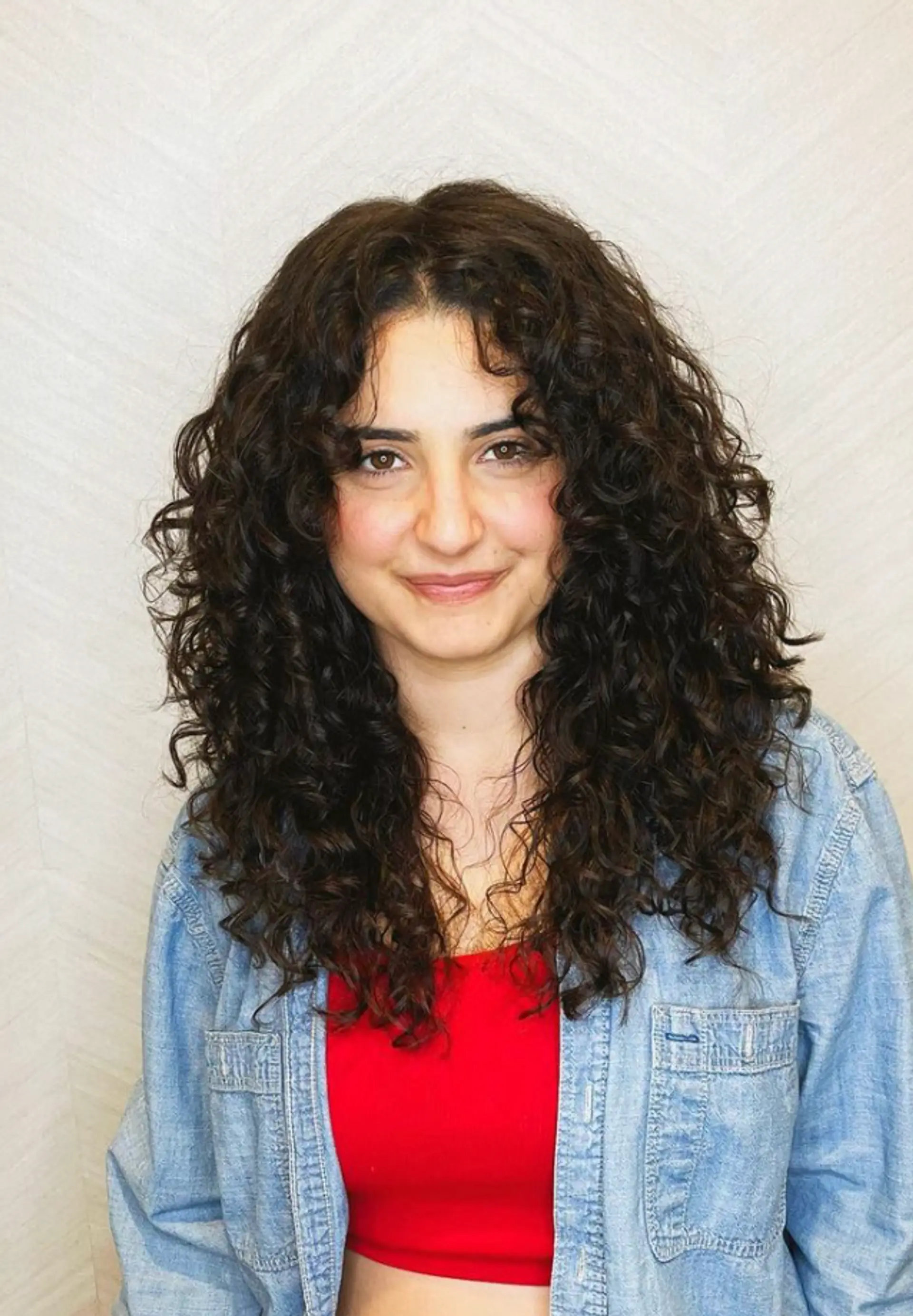 Long, naturally curly dark brown hair with thick volume and low layers, falling past the shoulders in voluminous, defined spirals.

Cut and style by @juliamannino_hair 1