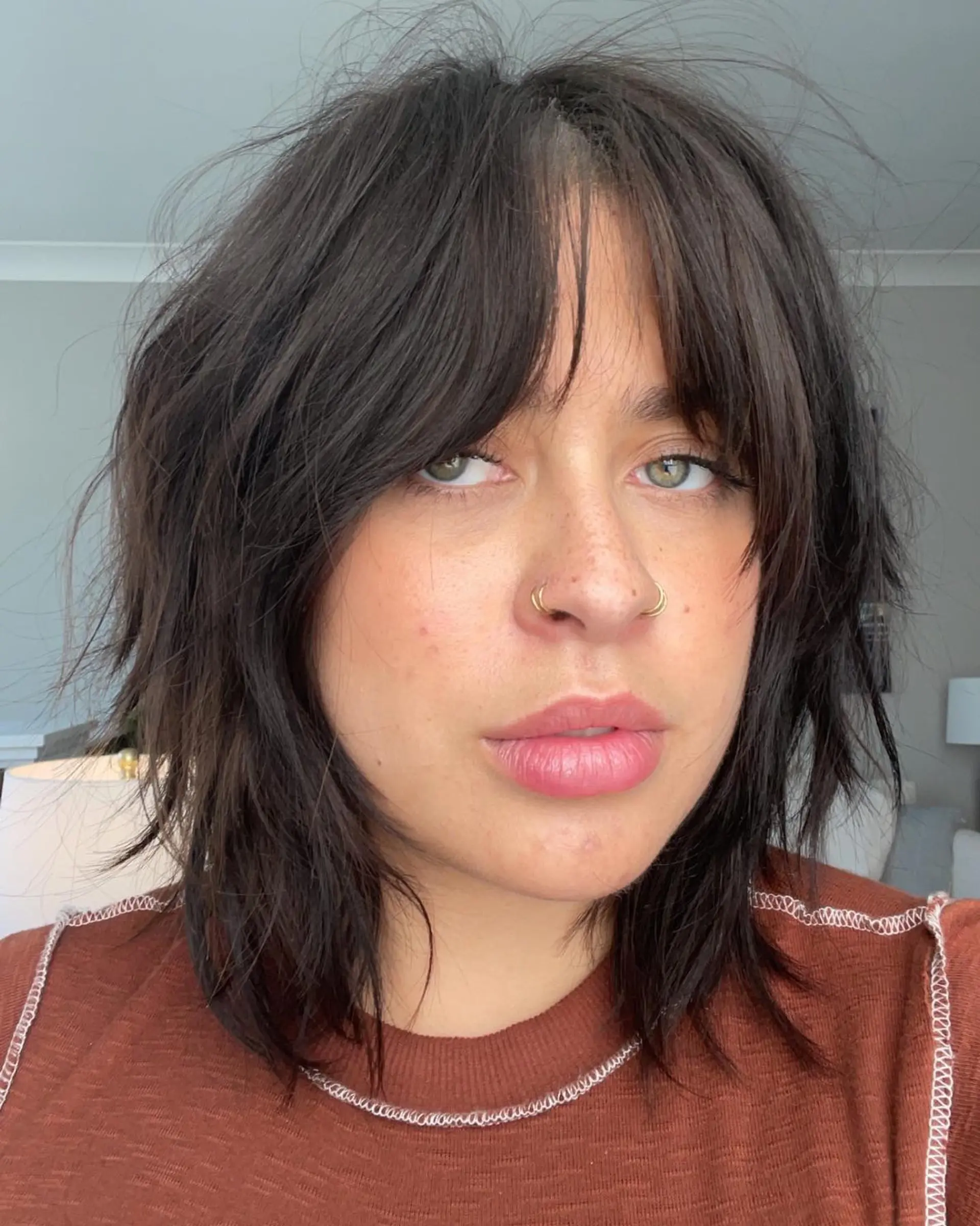 A trendy shag haircut with choppy layers and face-framing curtain bangs. 1