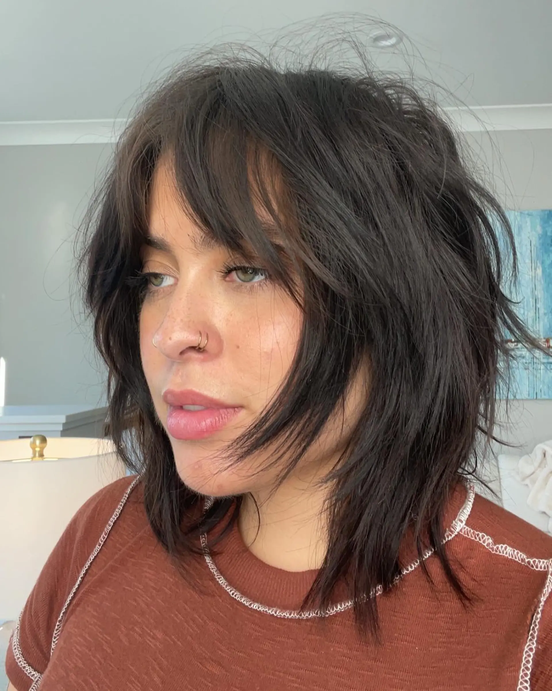 A trendy shag haircut with choppy layers and face-framing curtain bangs. 2