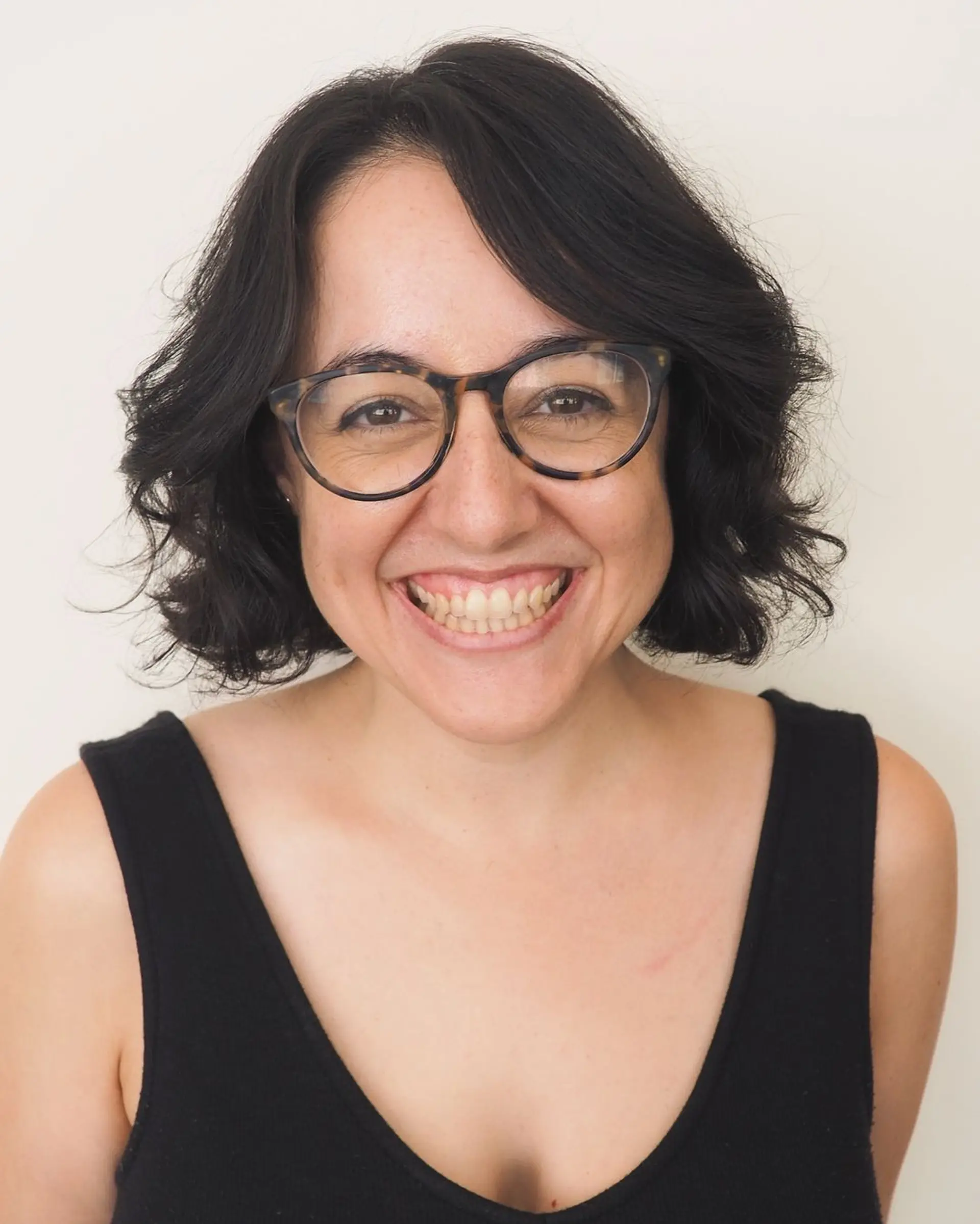 Casually tousled short bob with natural waves and a side part, offering a playful yet sophisticated look. 1