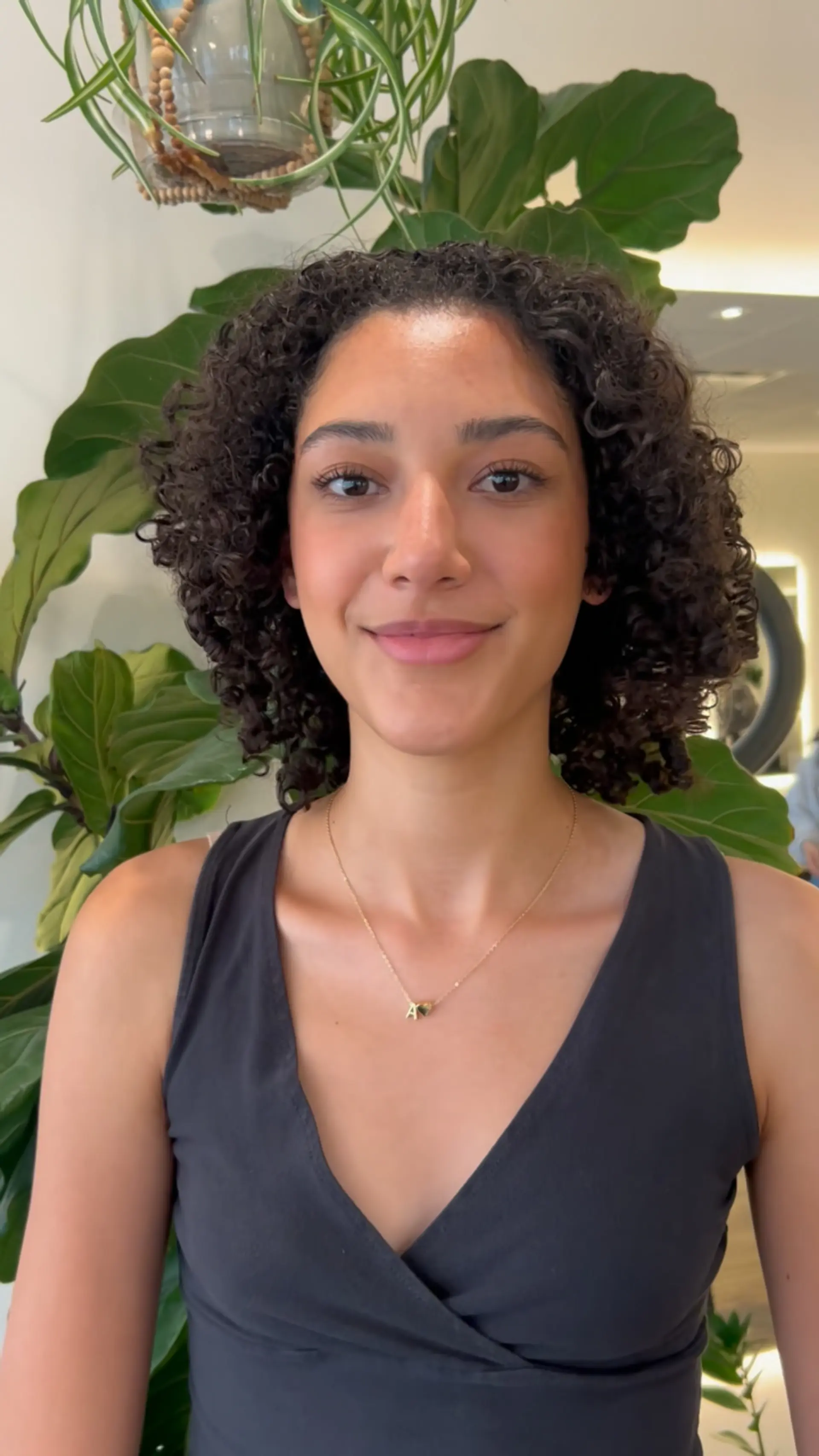A shoulder-length curly cut featuring deeply hydrated, bouncy ringlets with healthy definition and natural volume. 1