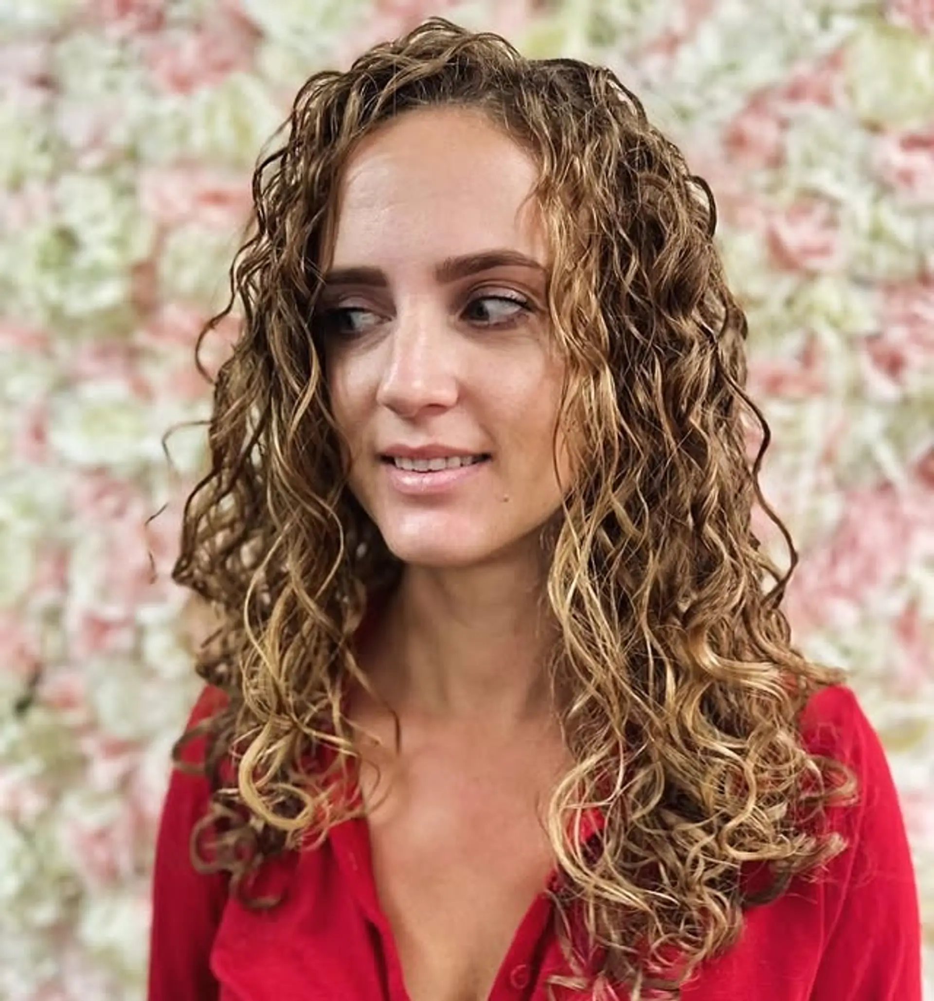 A medium-length curly hairstyle with defined ringlets and golden blonde color. 1