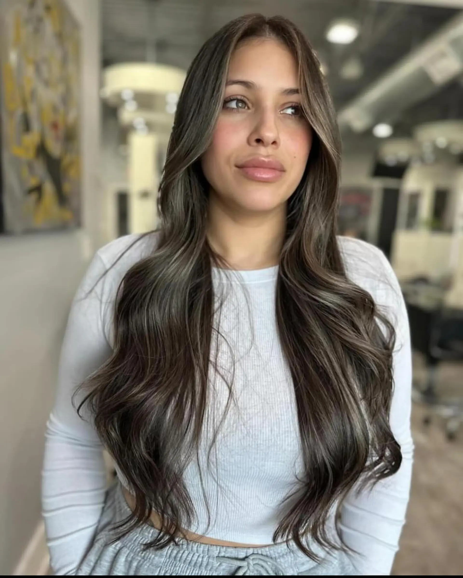 Long, layered, wavy hair with face-framing layers and a bronde balayage. 3