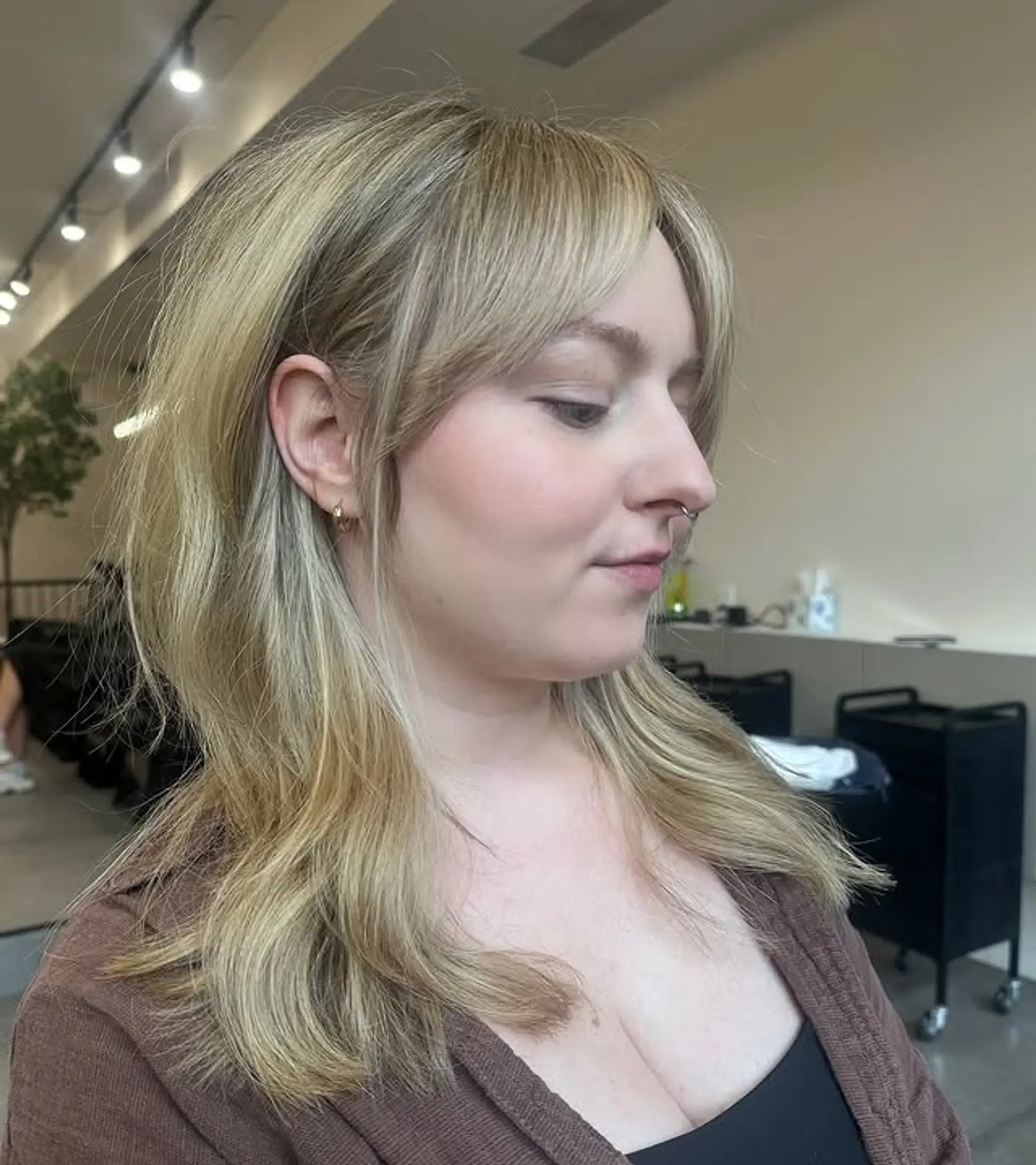 A modern shag haircut with face-framing layers and wispy bangs. 1