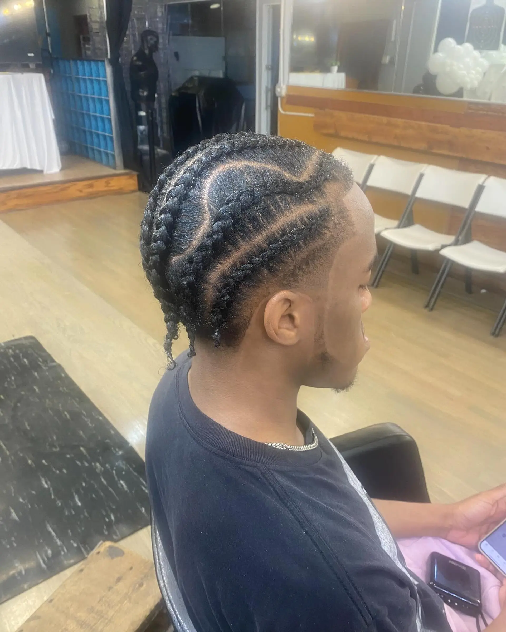 Intricate braids with a clean fade for a modern men's look. 1