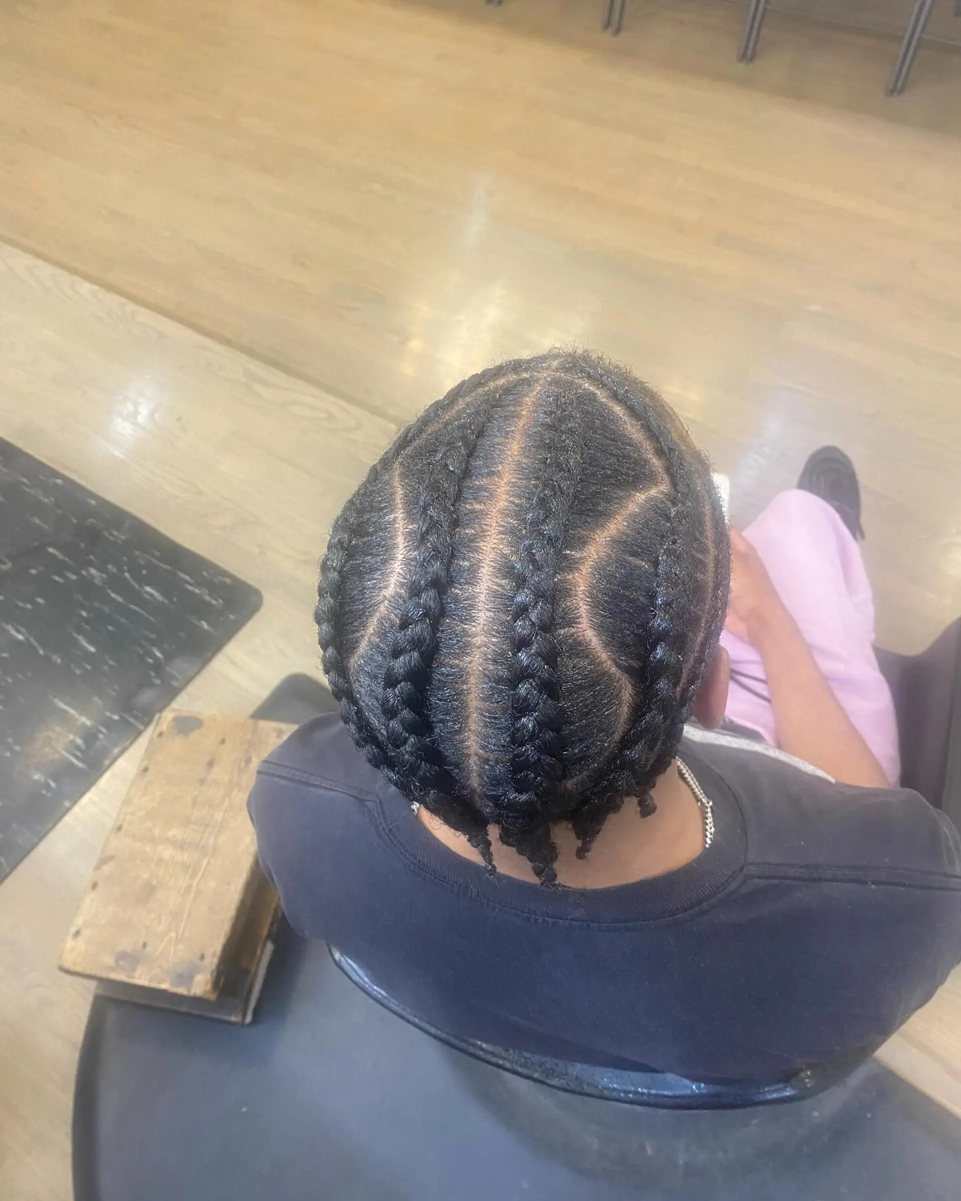 Intricate braids with a clean fade for a modern men's look. 2