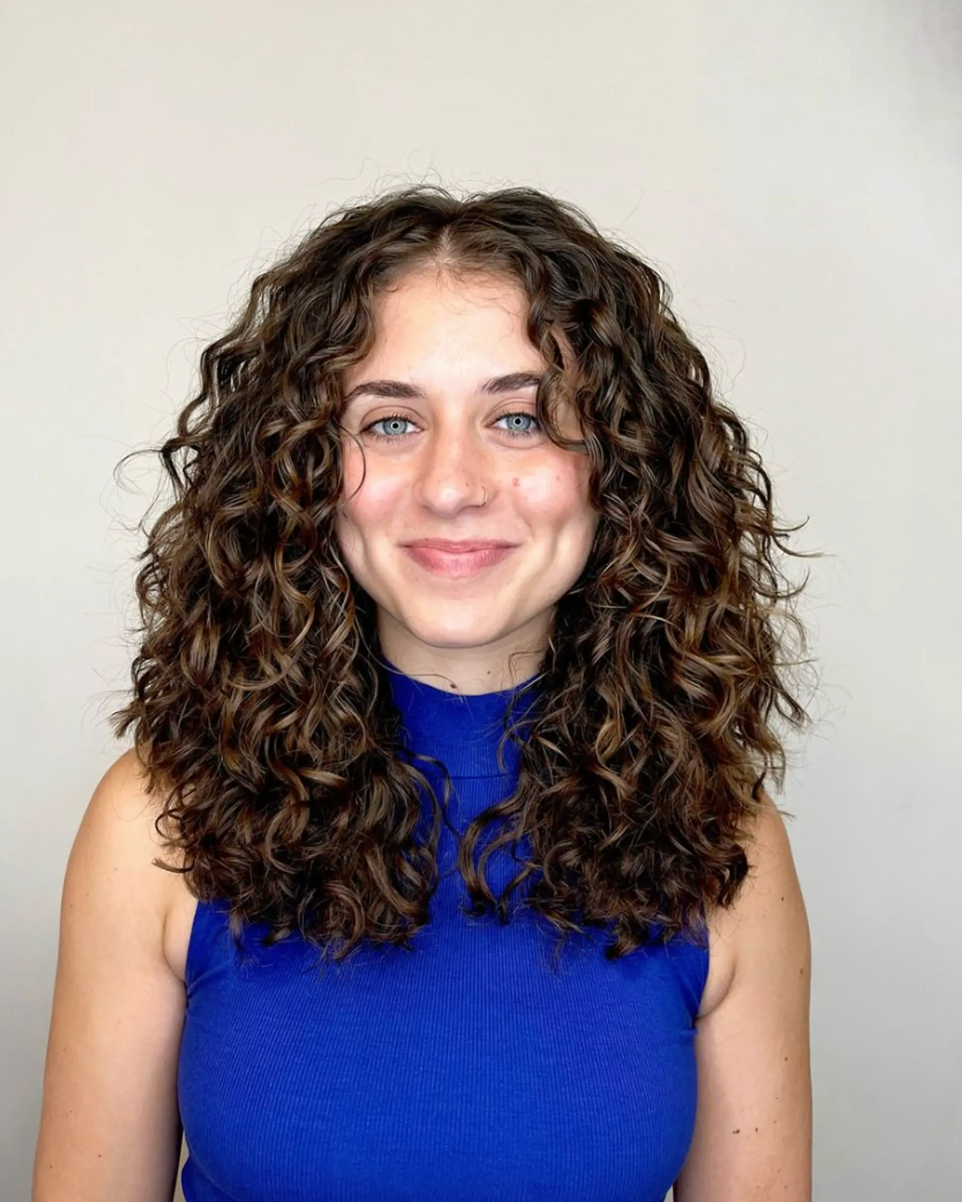 Natural, medium-length curly hair with defined ringlets and a voluminous, frizz-free finish.

Cut and style by @juliamannino_hair
 1