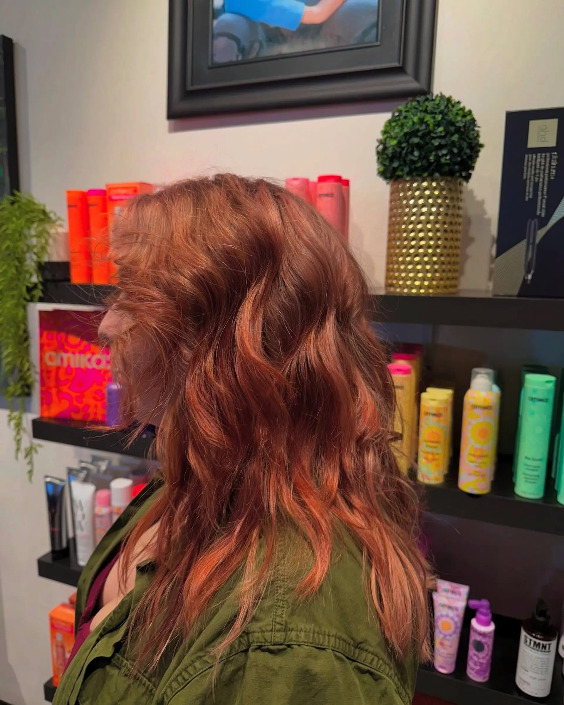 Medium-length layered hair styled in soft, undone waves with a vibrant multidimensional copper and auburn hue. 1