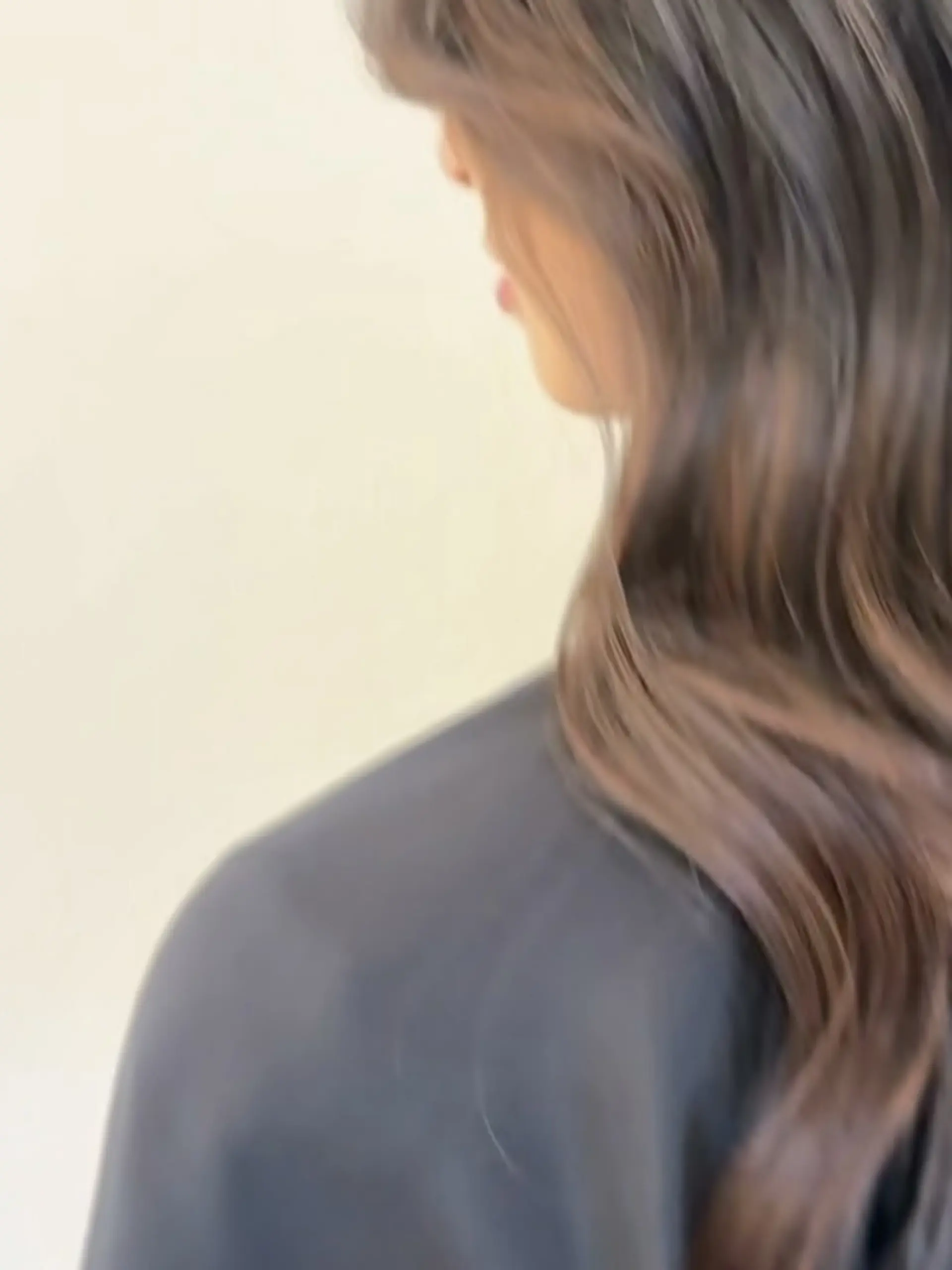 Long warm brunette hair styled into soft, effortless waves. 1