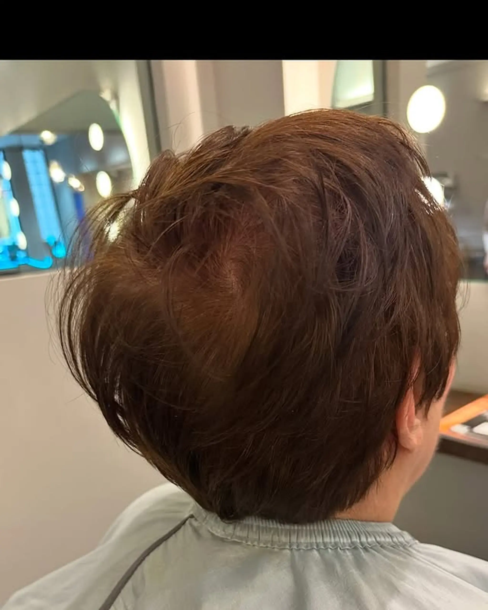 A textured bob haircut with layers to add volume and movement.