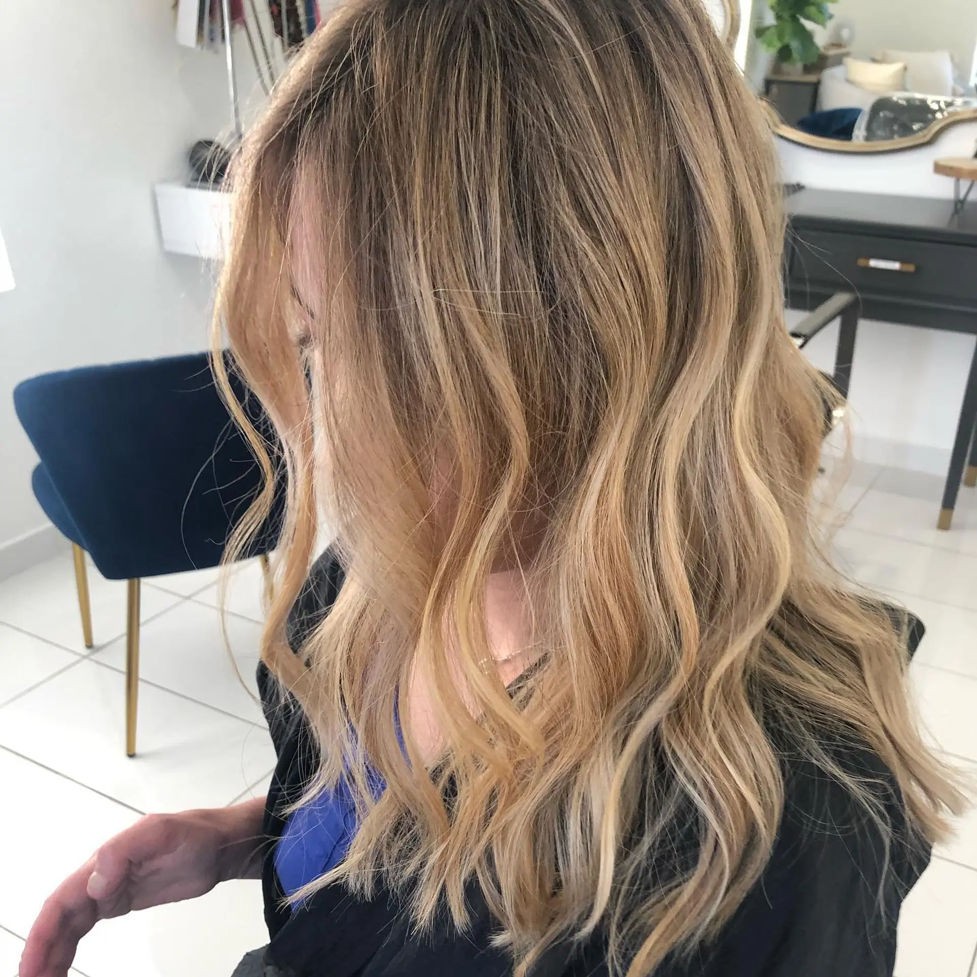 Medium-to-long hair styled with dimensional warm blonde balayage and effortless, soft loose waves. 1