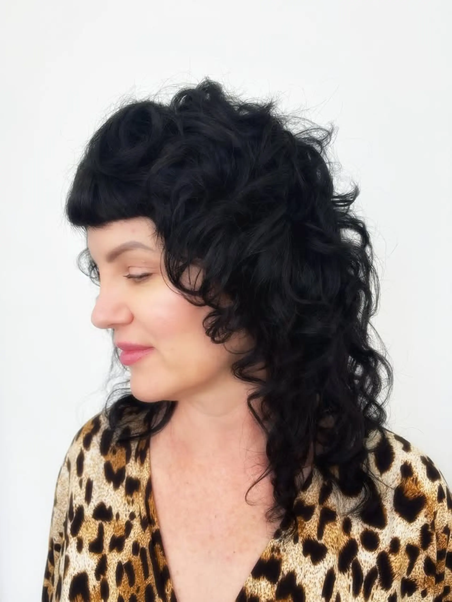 A modern shag with choppy layers and short, blunt bangs. 1