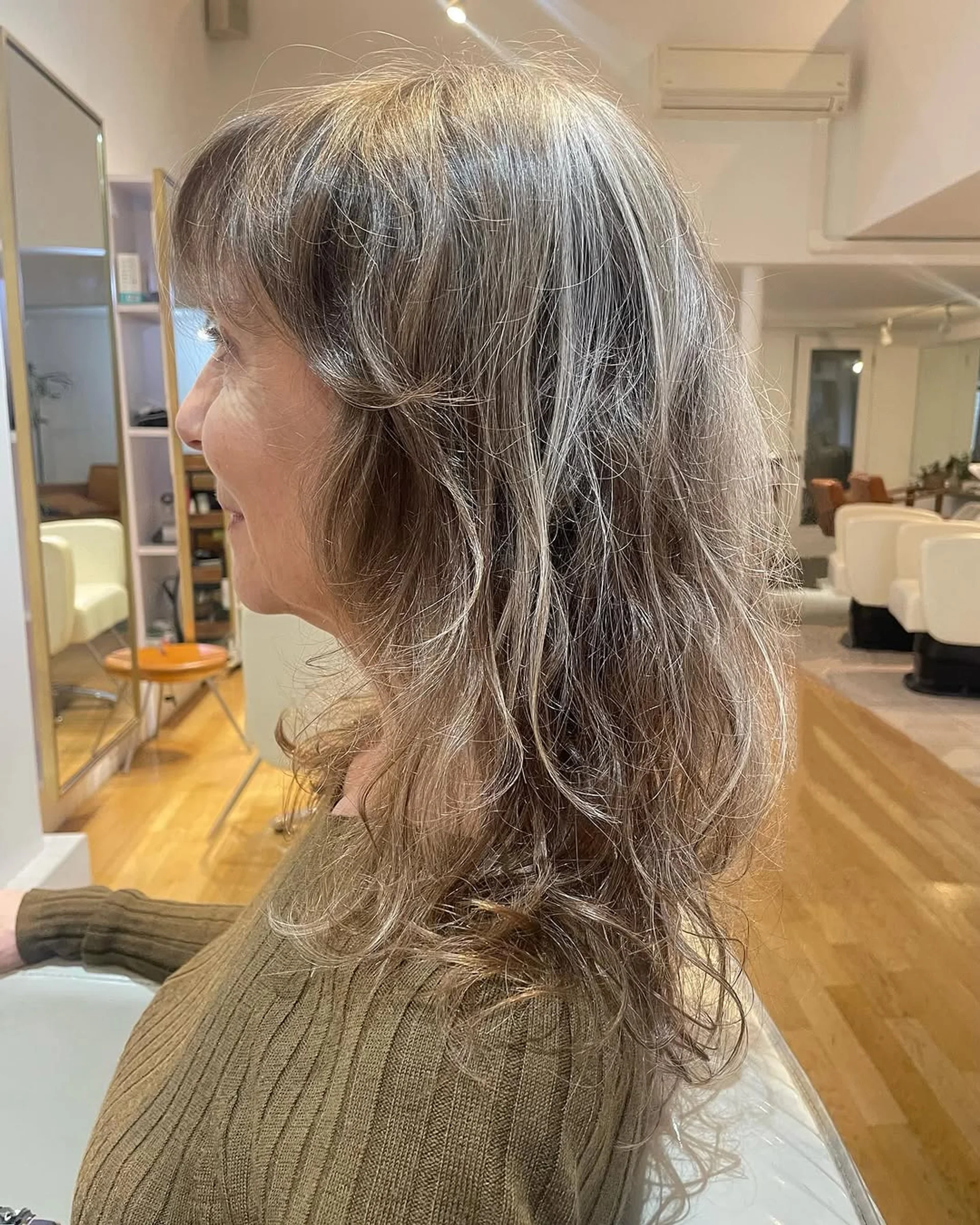 Medium length layered bronde hair with beachy waves and highlights, showcasing modern texture. - Preview 1