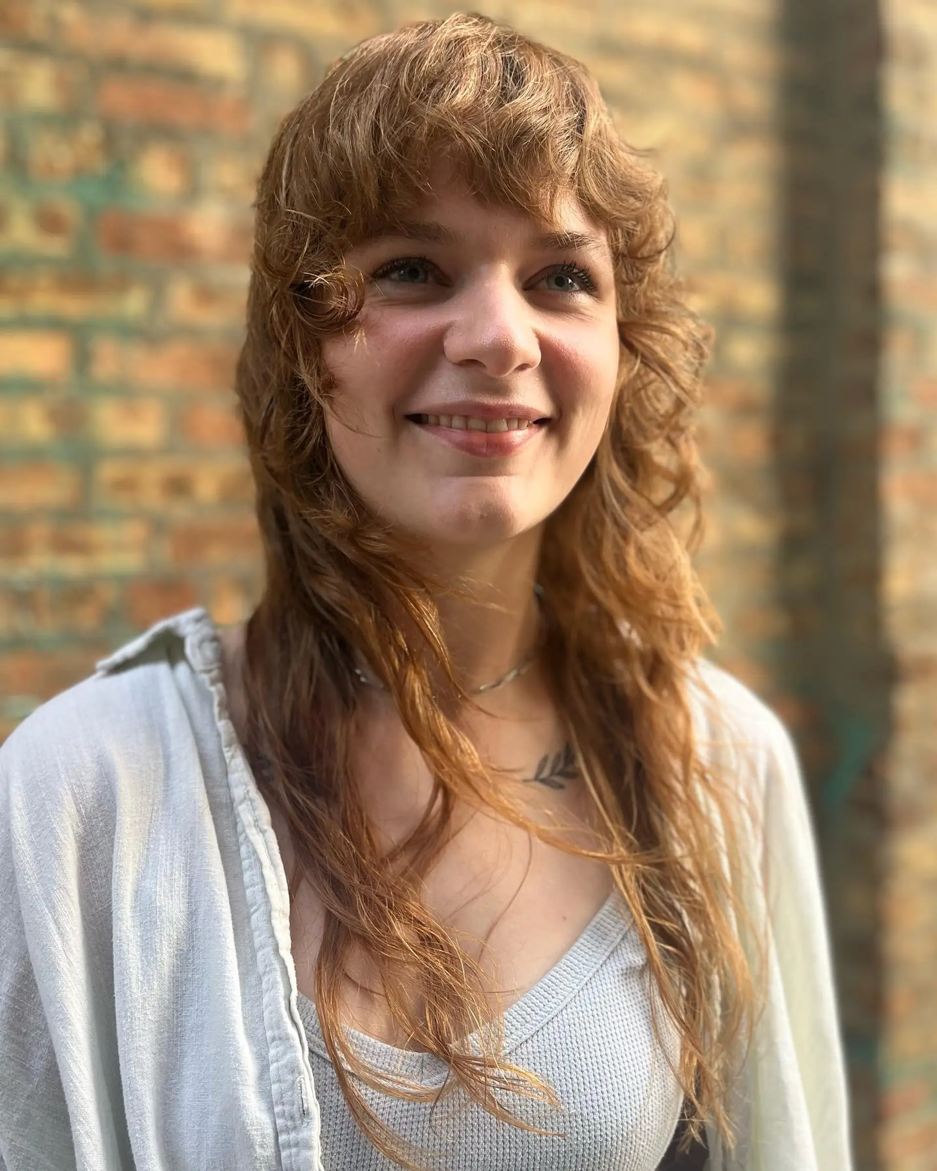 A trendy shag mullet with textured layers and wispy bangs. 2