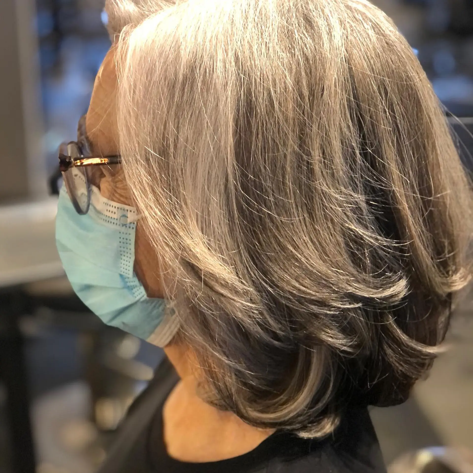 A layered gray bob featuring feathered textures and curled-under ends that create volume and soft movement. 1