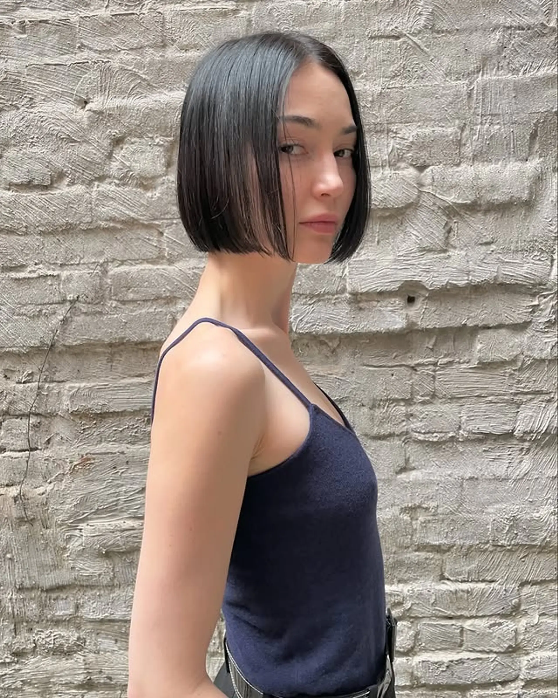 A chin-length blunt bob with subtle face-framing. 1