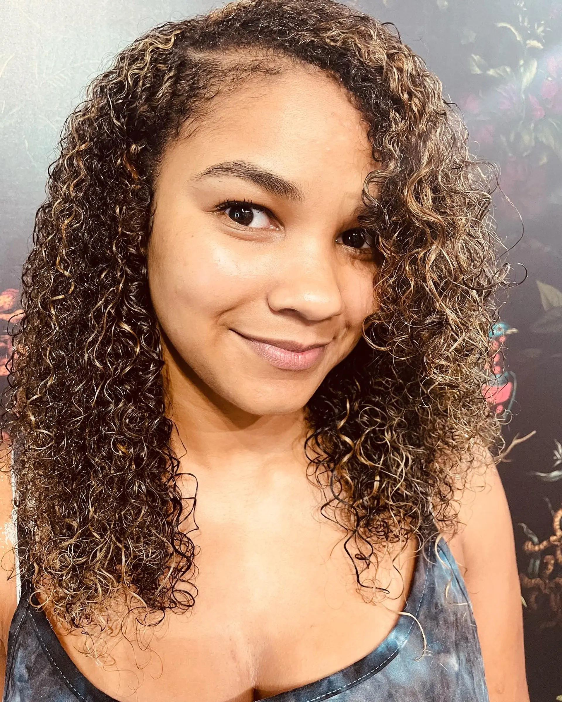 Medium-length defined curls featuring warm golden blonde highlights on a dark brown base. 1