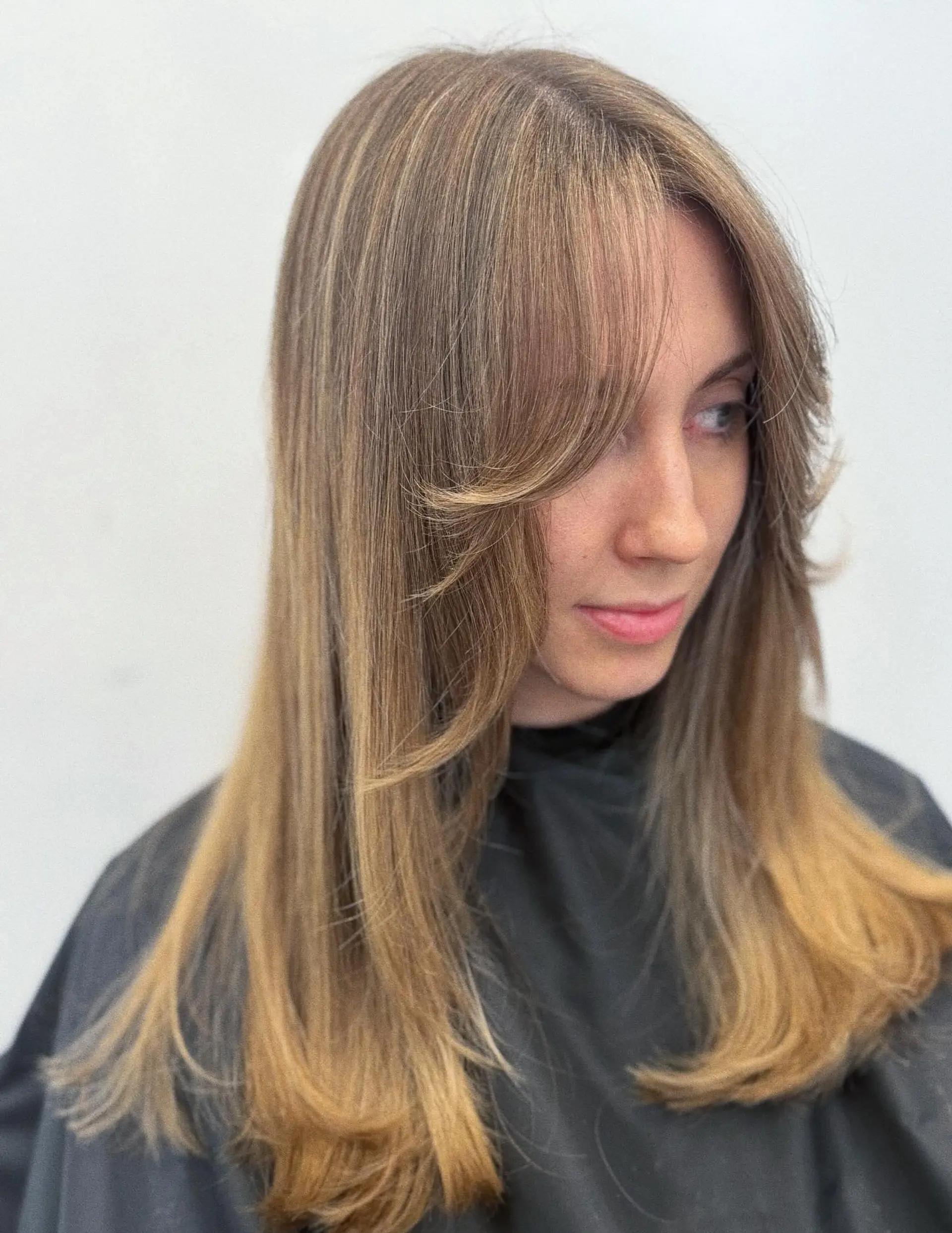 Long smooth hair styled with soft face-framing curtain bangs and feathered layers. 1