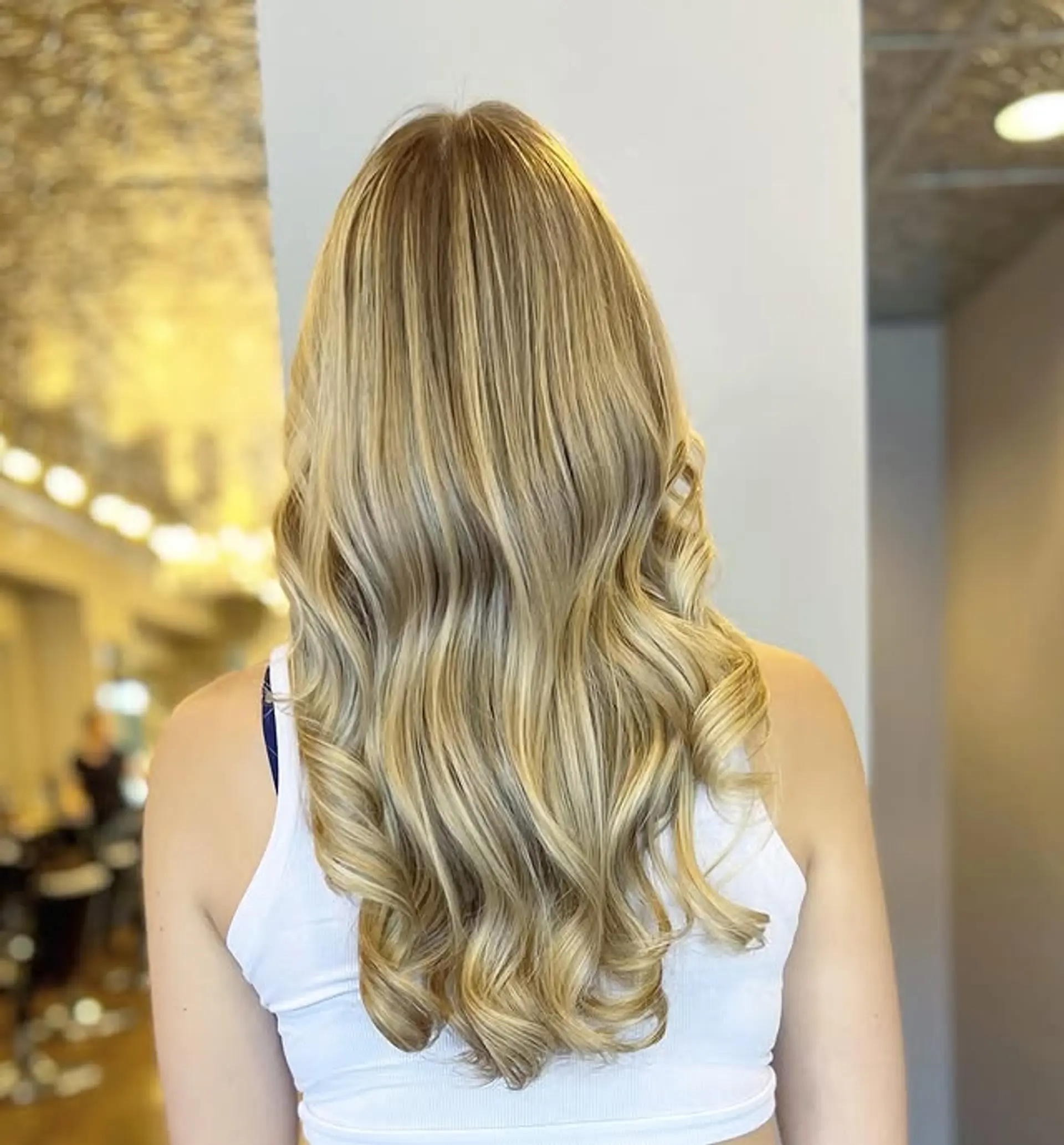 Long wavy hairstyle with face-framing layers and balayage highlights. 1