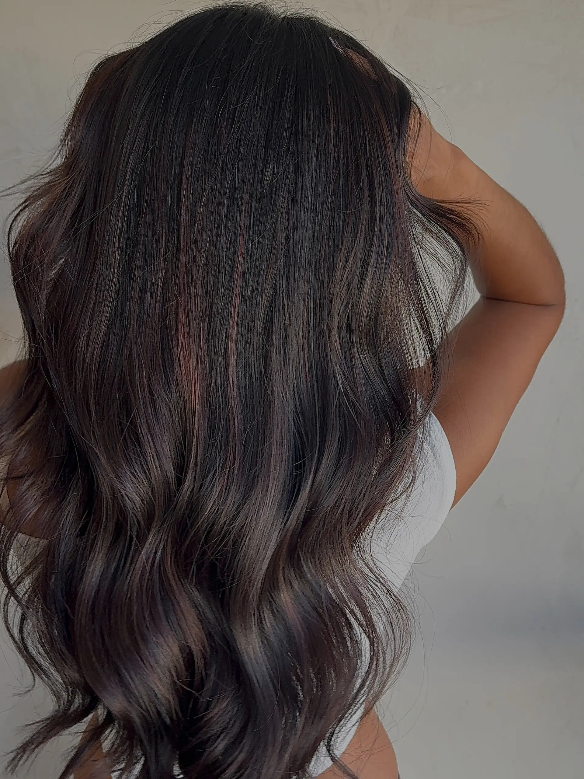 Long, glossy dark espresso brown hair styled in soft, loose flowing waves. 1