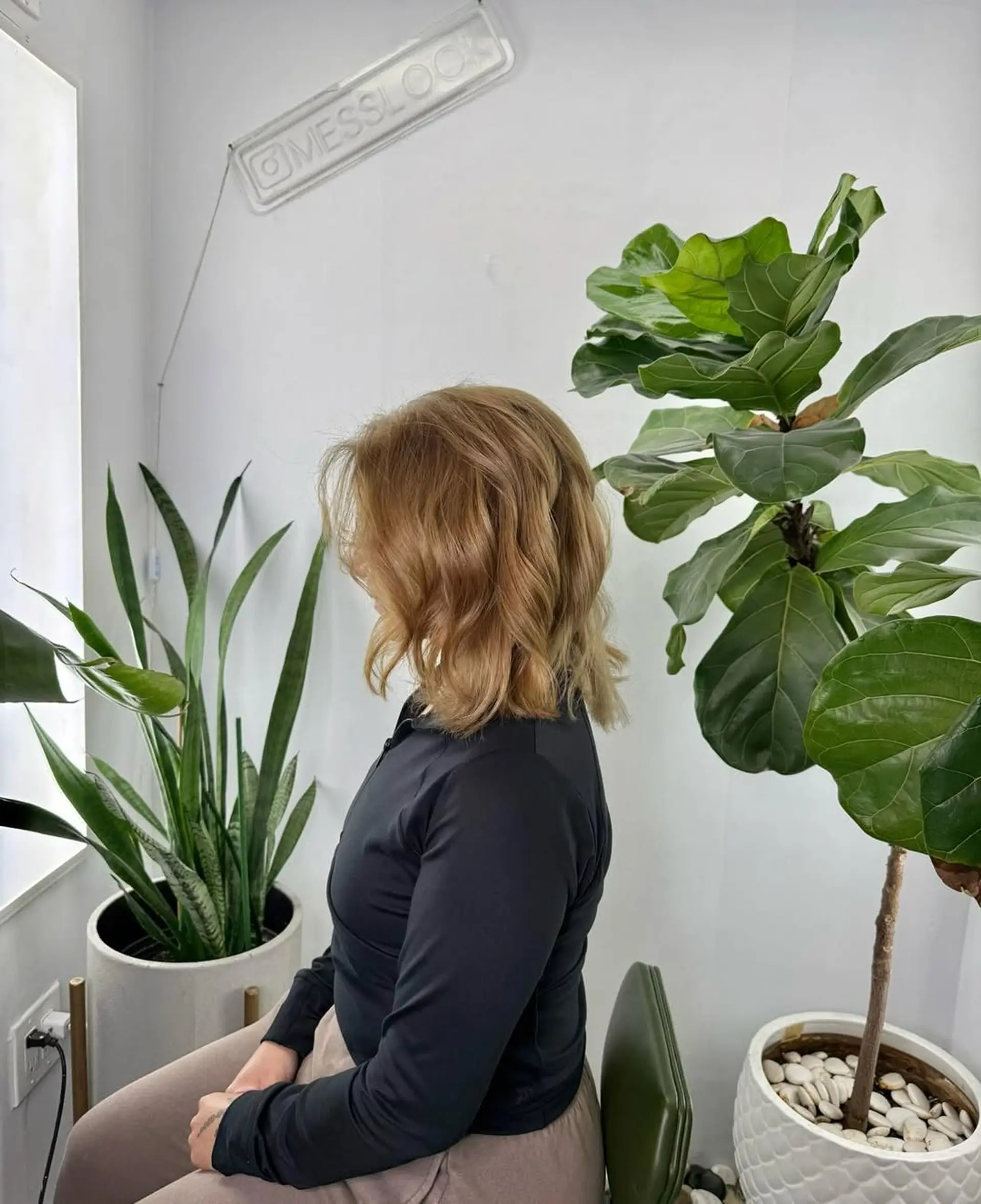 A medium-length, wavy layered cut that hits at the shoulders, featuring soft movement and a textured, modern finish. 1