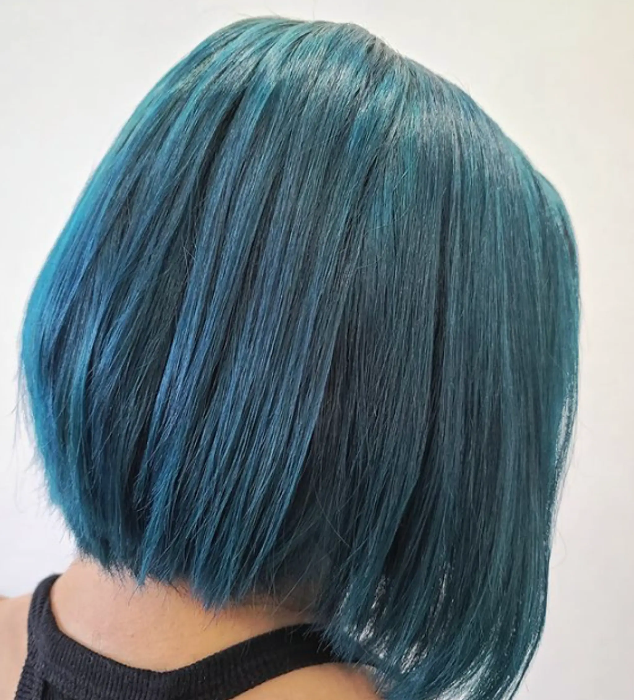 A straight, short bob with a blunt cut featuring vibrant teal and blue colors.