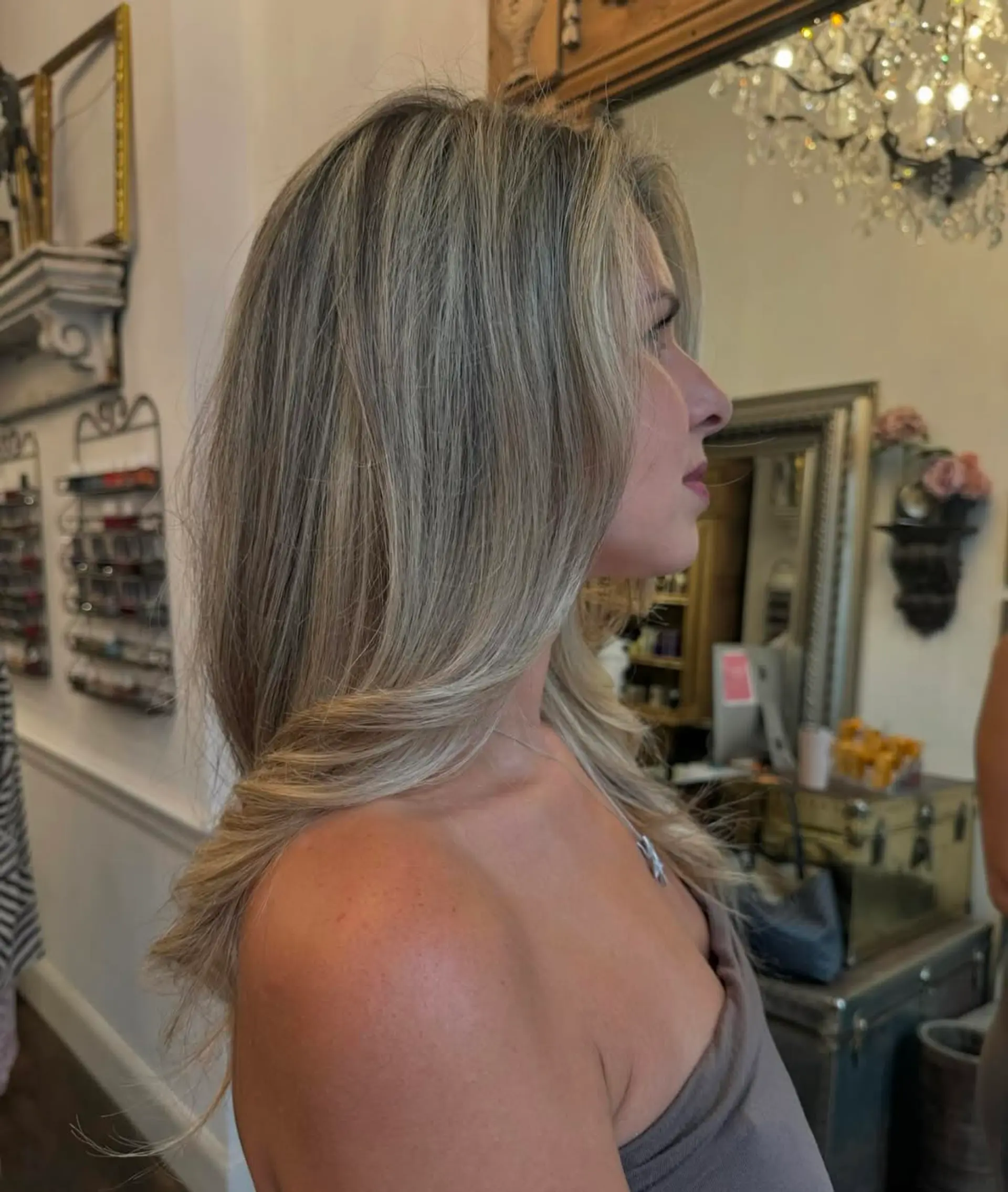 Long, wavy hair with a mix of silver and blonde tones, featuring layered waves and natural volume. 2