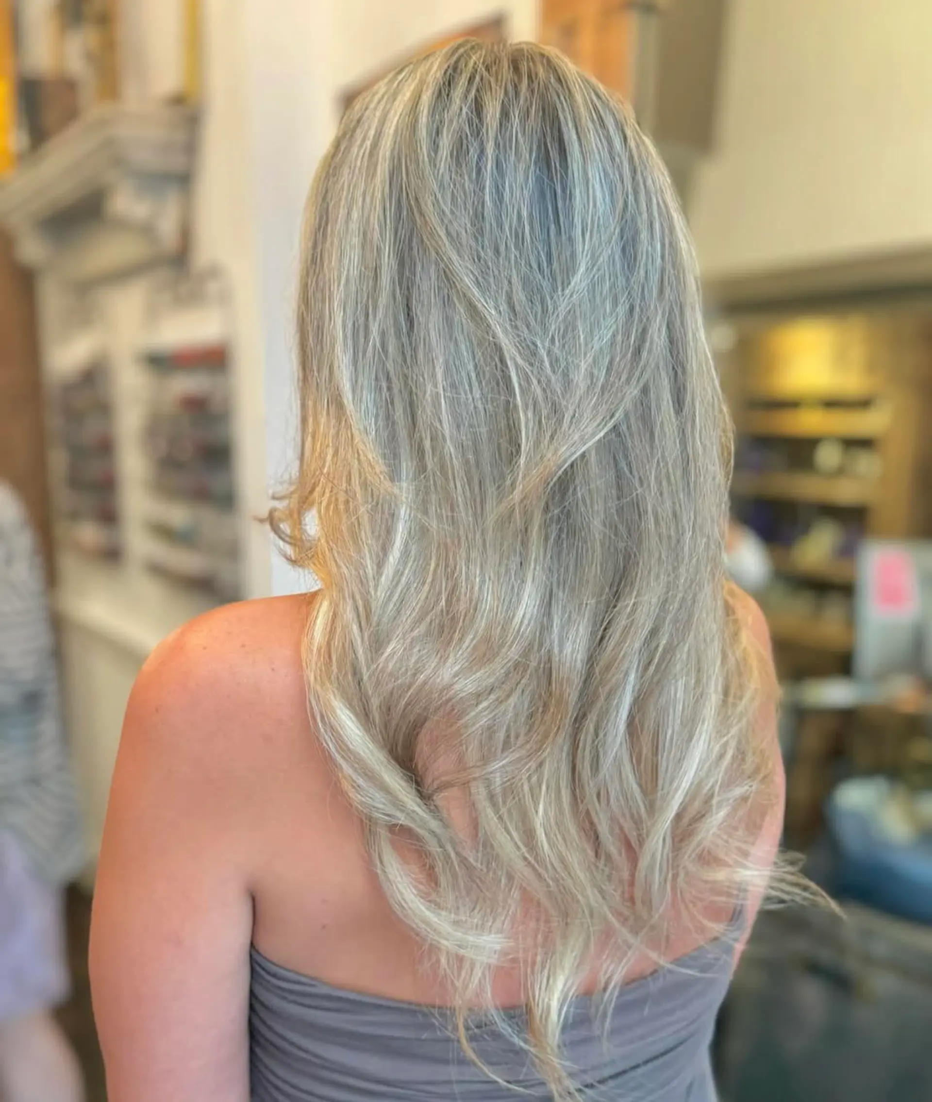Long, wavy hair with a mix of silver and blonde tones, featuring layered waves and natural volume. 3