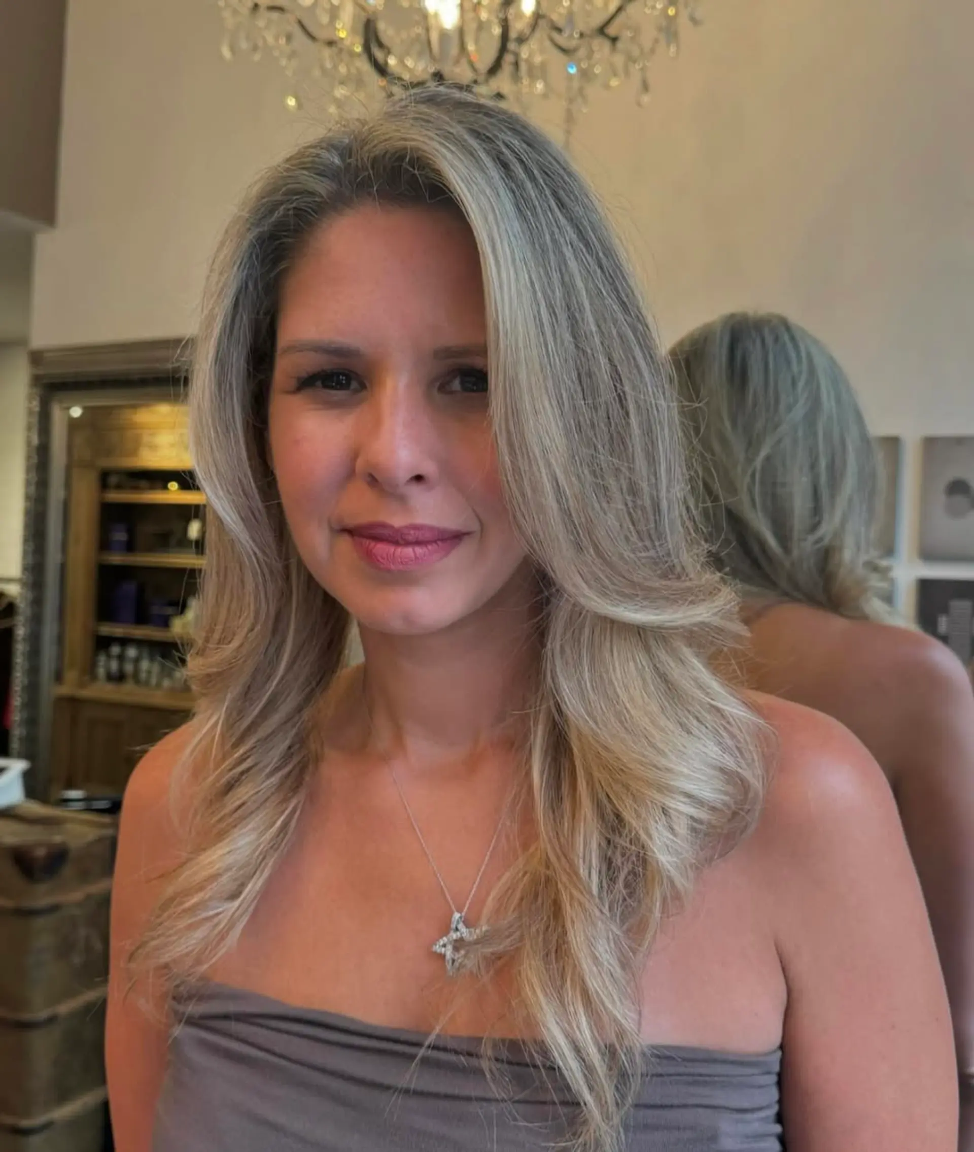 Long, wavy hair with a mix of silver and blonde tones, featuring layered waves and natural volume. 4