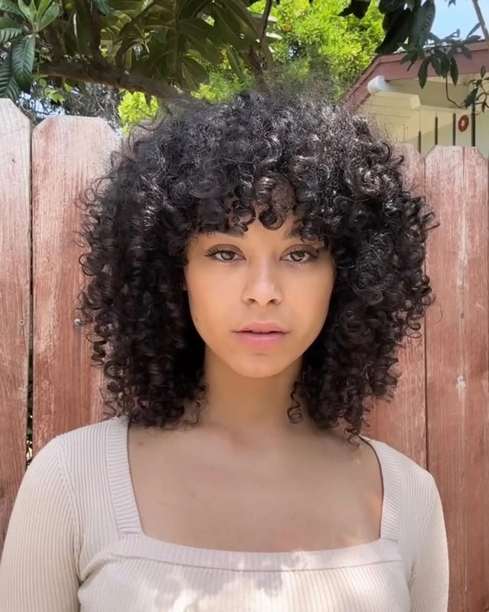 A curly shag haircut with face-framing bangs. 1