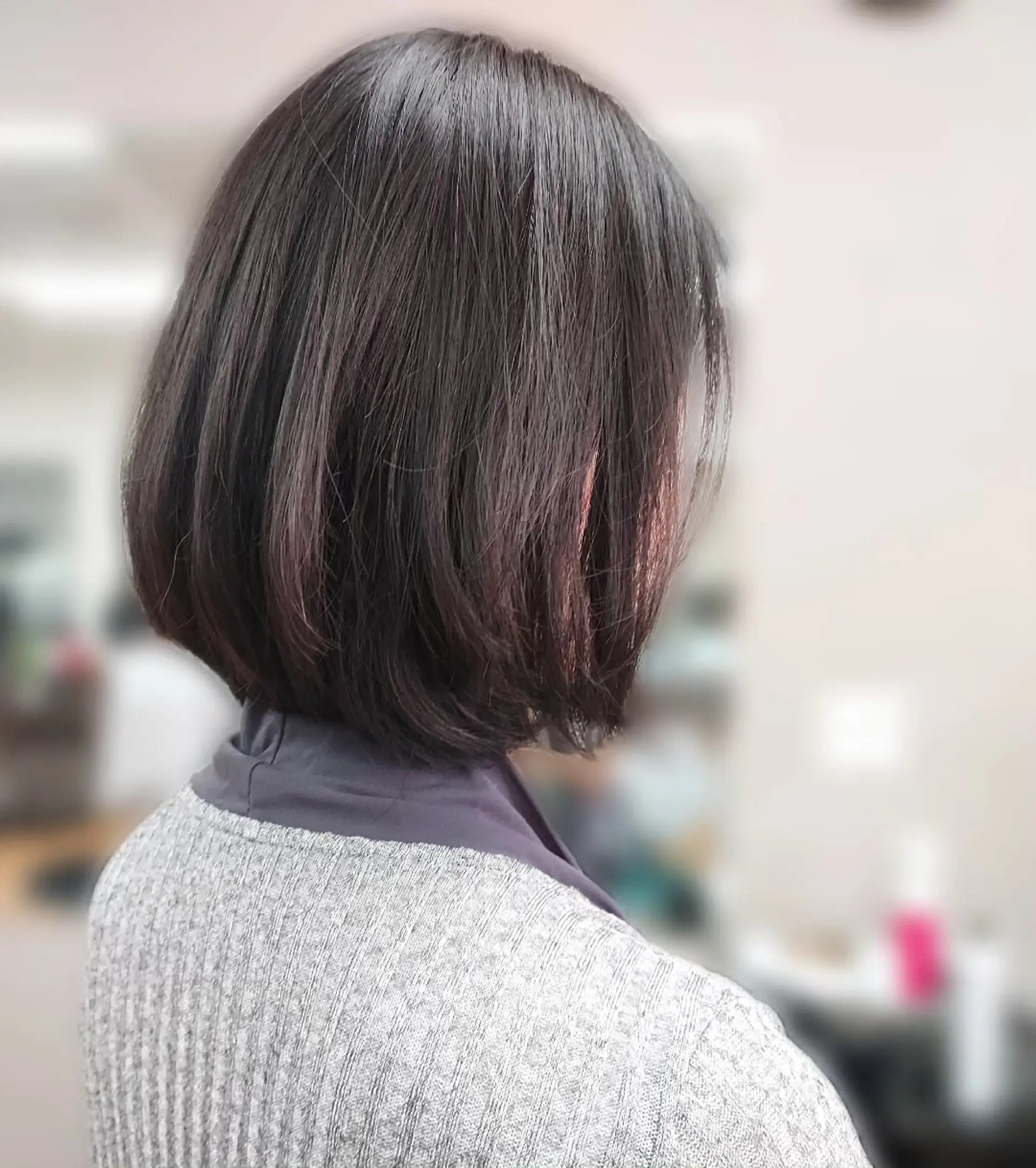 A classic chin-length bob with subtly beveled ends and soft, dimensional dark brown color. 1