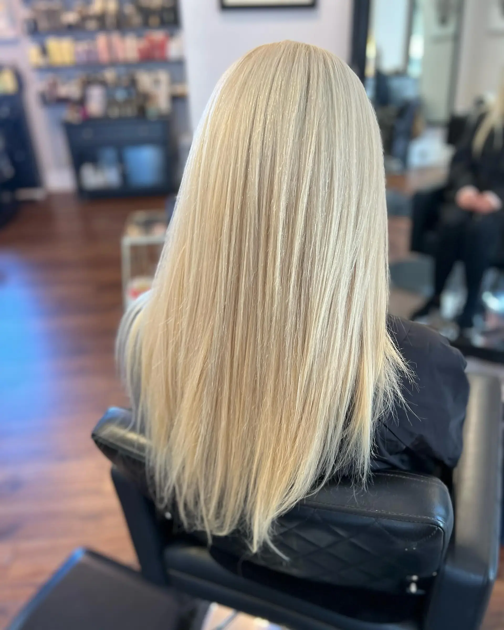Long, sleek straight icy blonde hair styled smoothly down the back. 1