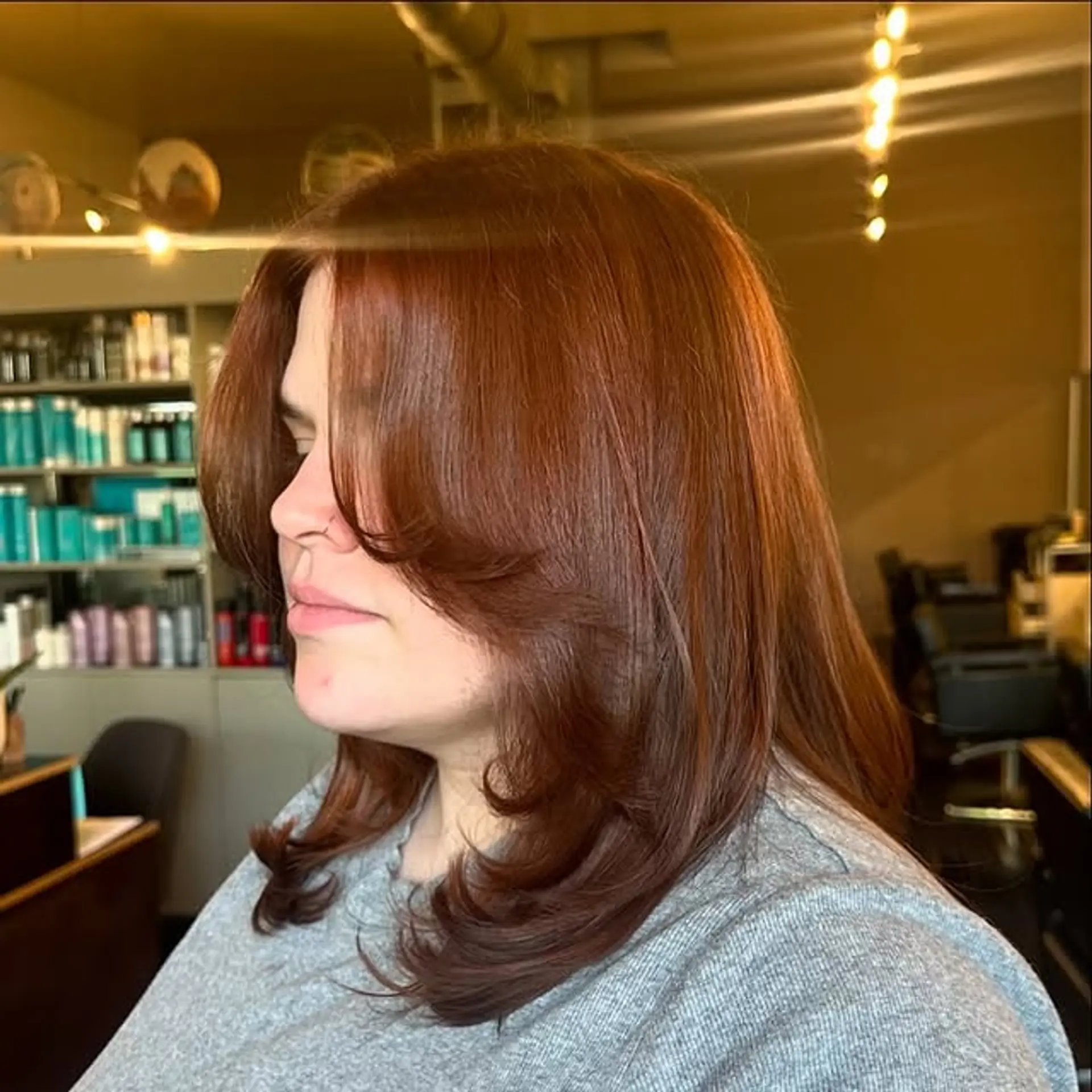 Medium-length layered haircut with a voluminous blowout and face-framing layers. 1