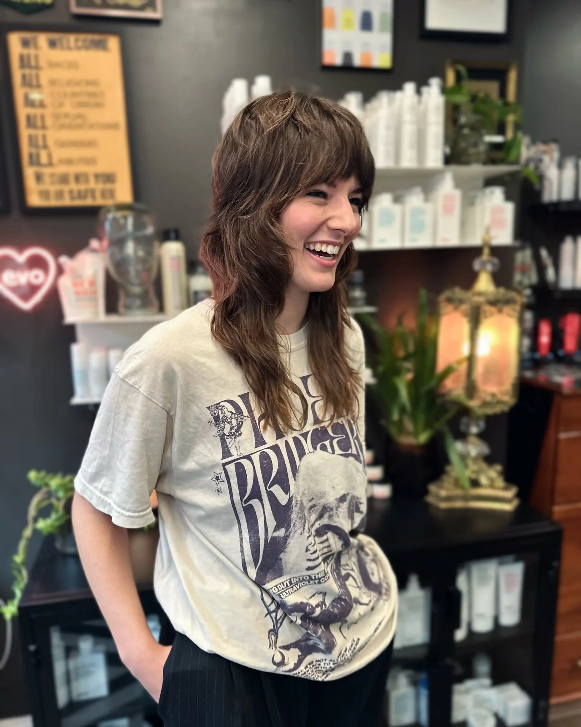A textured modern shag haircut featuring choppy crown layers, face-framing texture, and full front bangs. 1