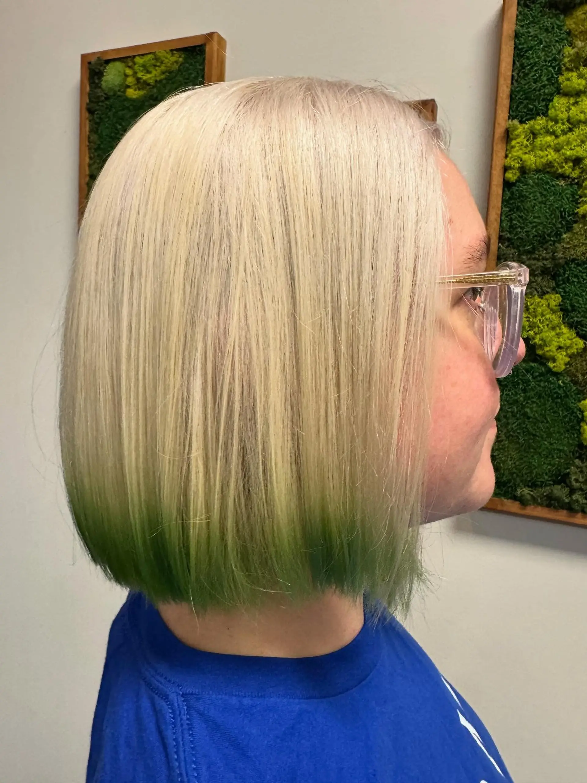 A sleek, straight chin-length blunt bob in platinum blonde accented with vivid green dipped ends. 1