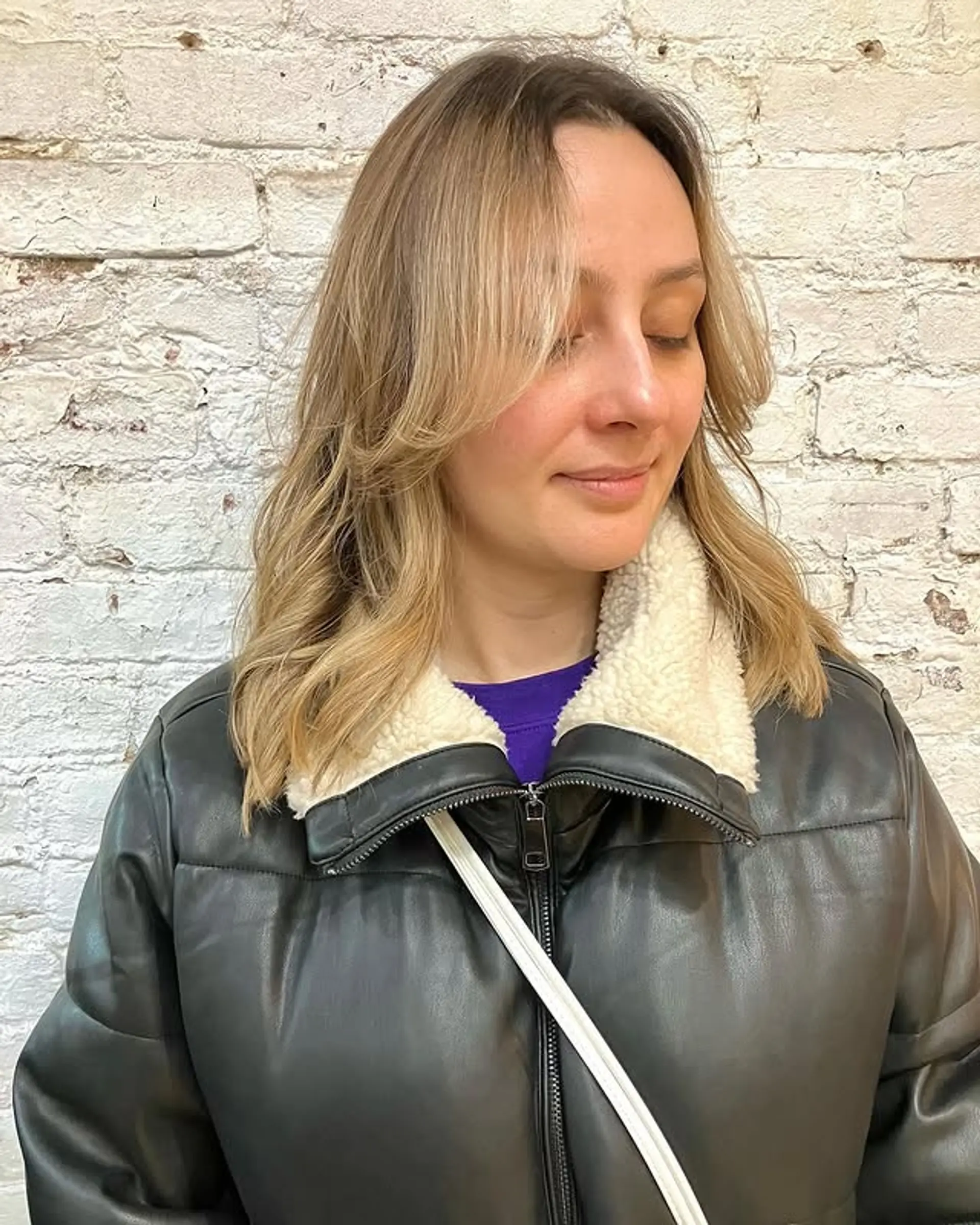 Medium-length wavy hair with curtain bangs and face-framing layers. 1