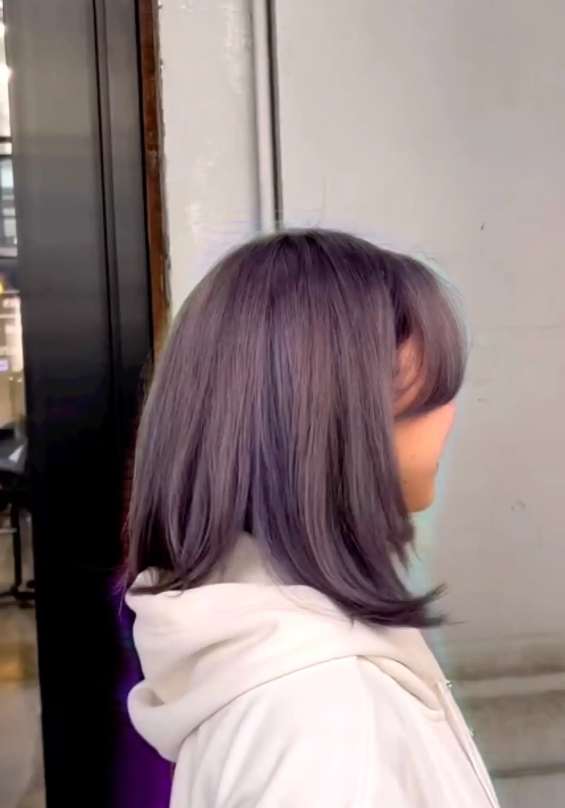 A shoulder-length lob with face-framing bangs in a smoky lavender shade. 1
