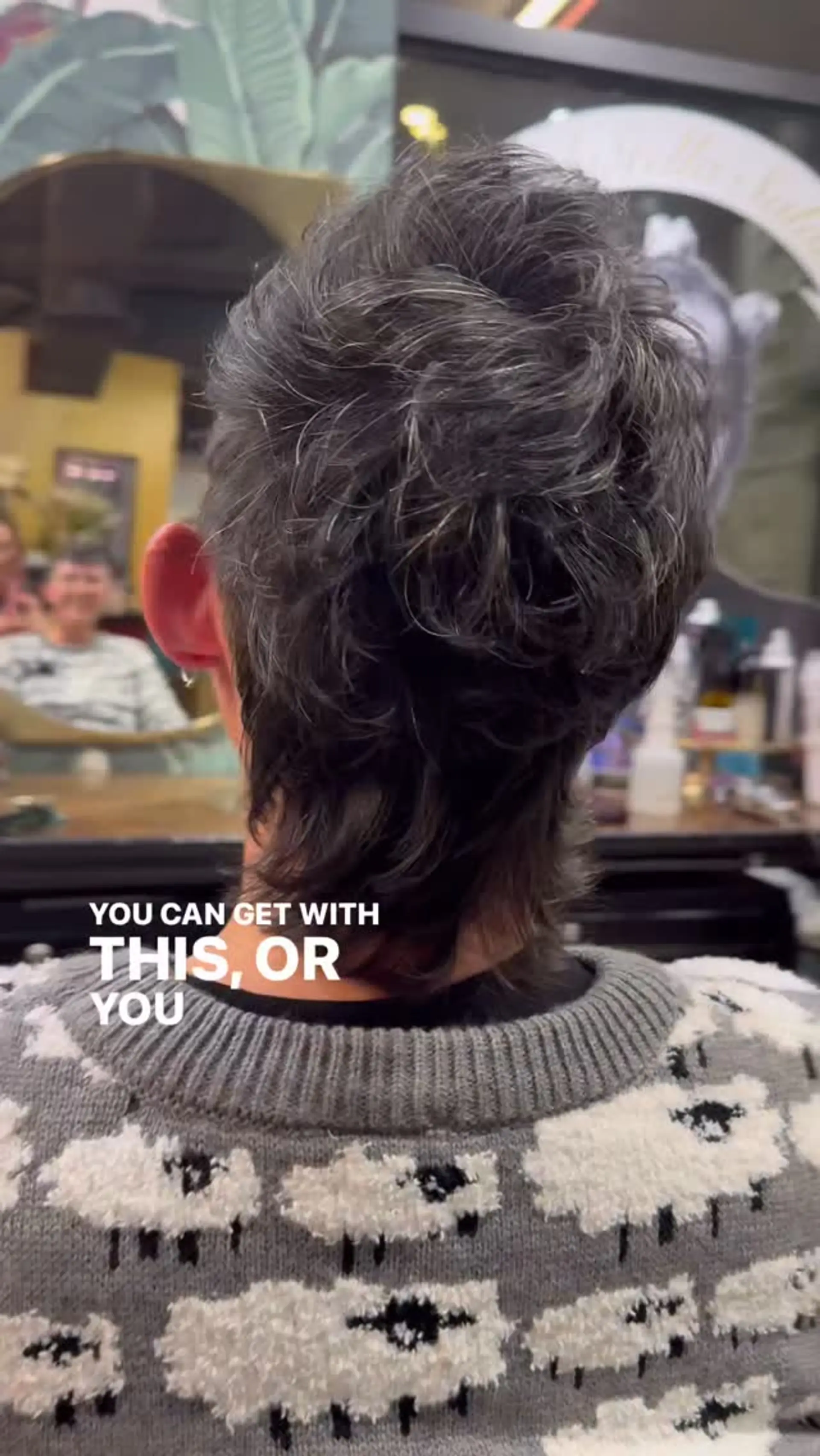A textured short pixie mullet cut with wavy, piecey layers through the crown and nape. 1
