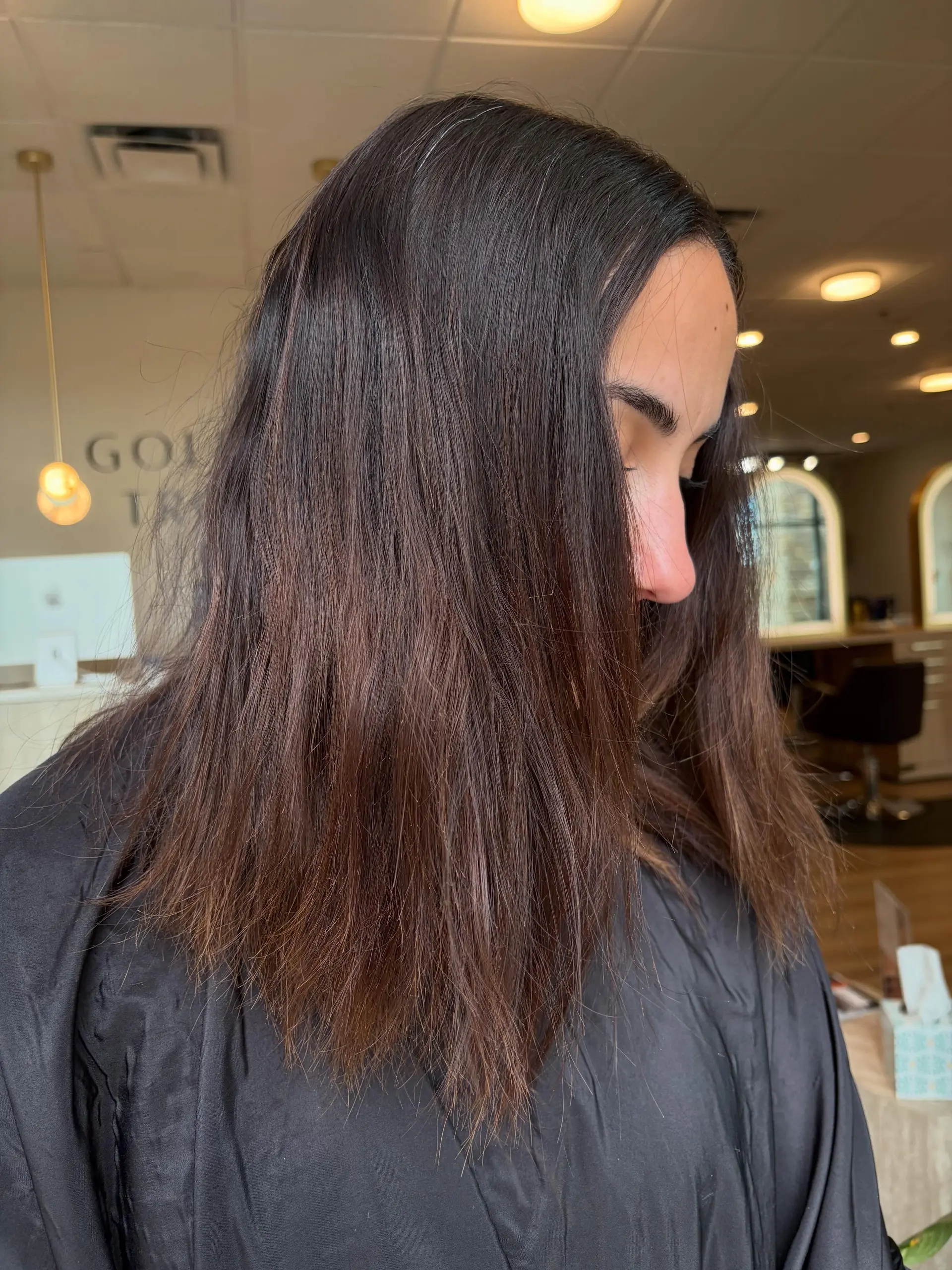 Medium-length deep chocolate brunette hair with subtle warm undertones, styled straight with natural movement. 1