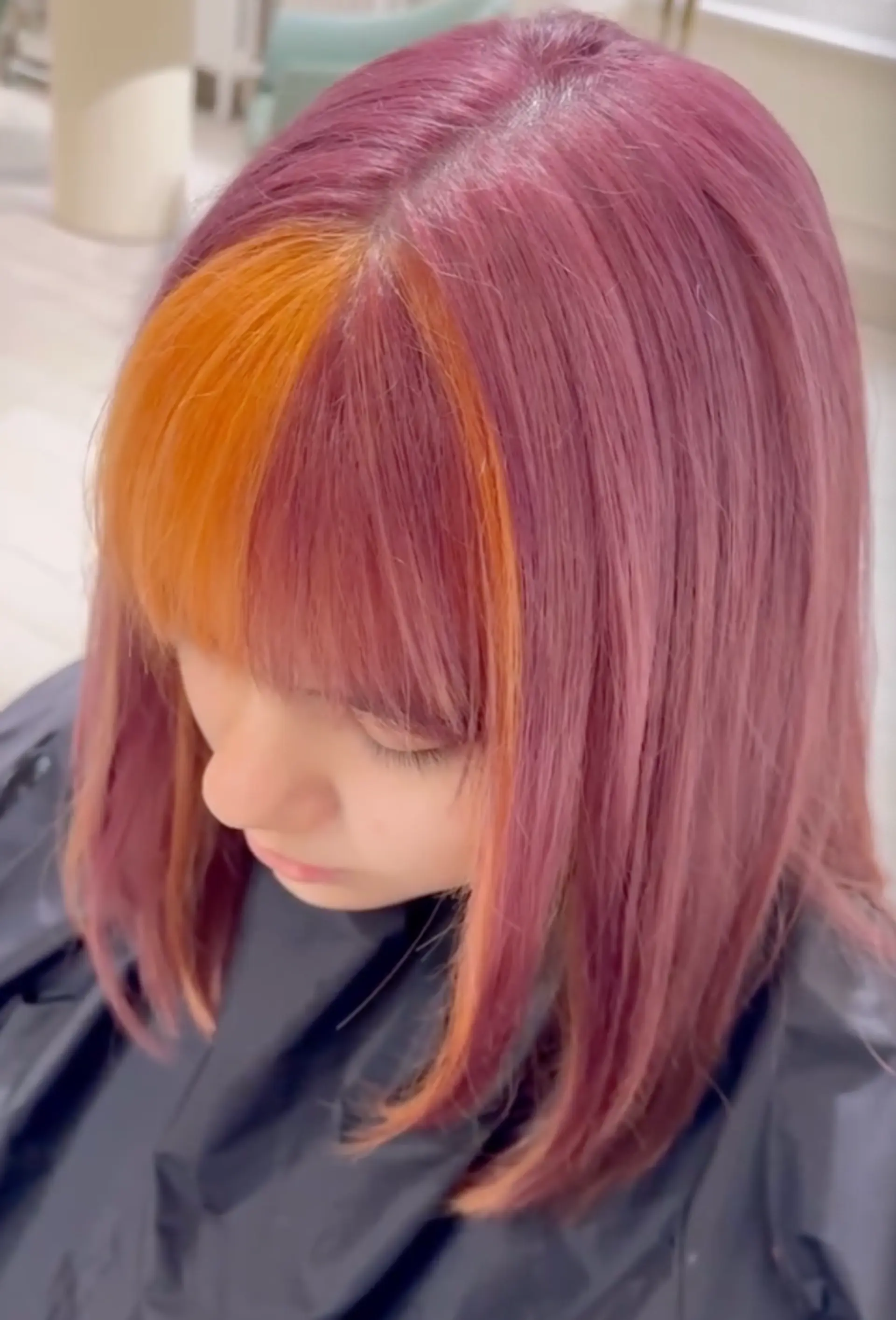 Medium length straight hair with bold purple and orange colors, side part, and blunt bangs.


Stylist: @yurihair.newyork 1